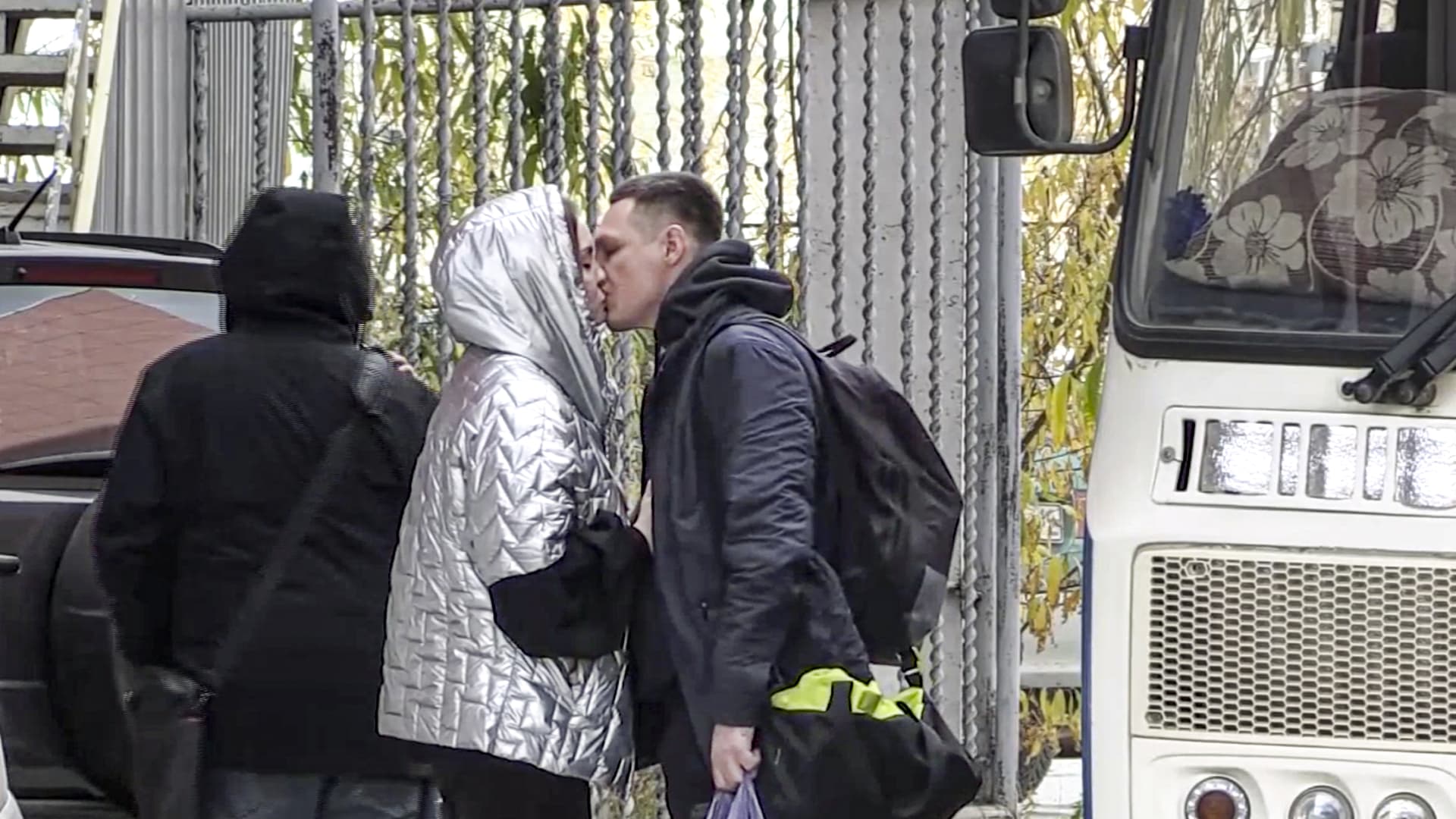 In this image taken from video, a Russian draftee kisses his partner before boarding a bus to be sent to the military units of the Eastern Military District, in Yakutsk, Russia, on Sept. 23, 2022. Mobilization is underway in Russia's Far Eastern region of Yakutia after President Vladimir Putin ordered a partial mobilization of reservists Wednesday to bolster his forces in Ukraine.