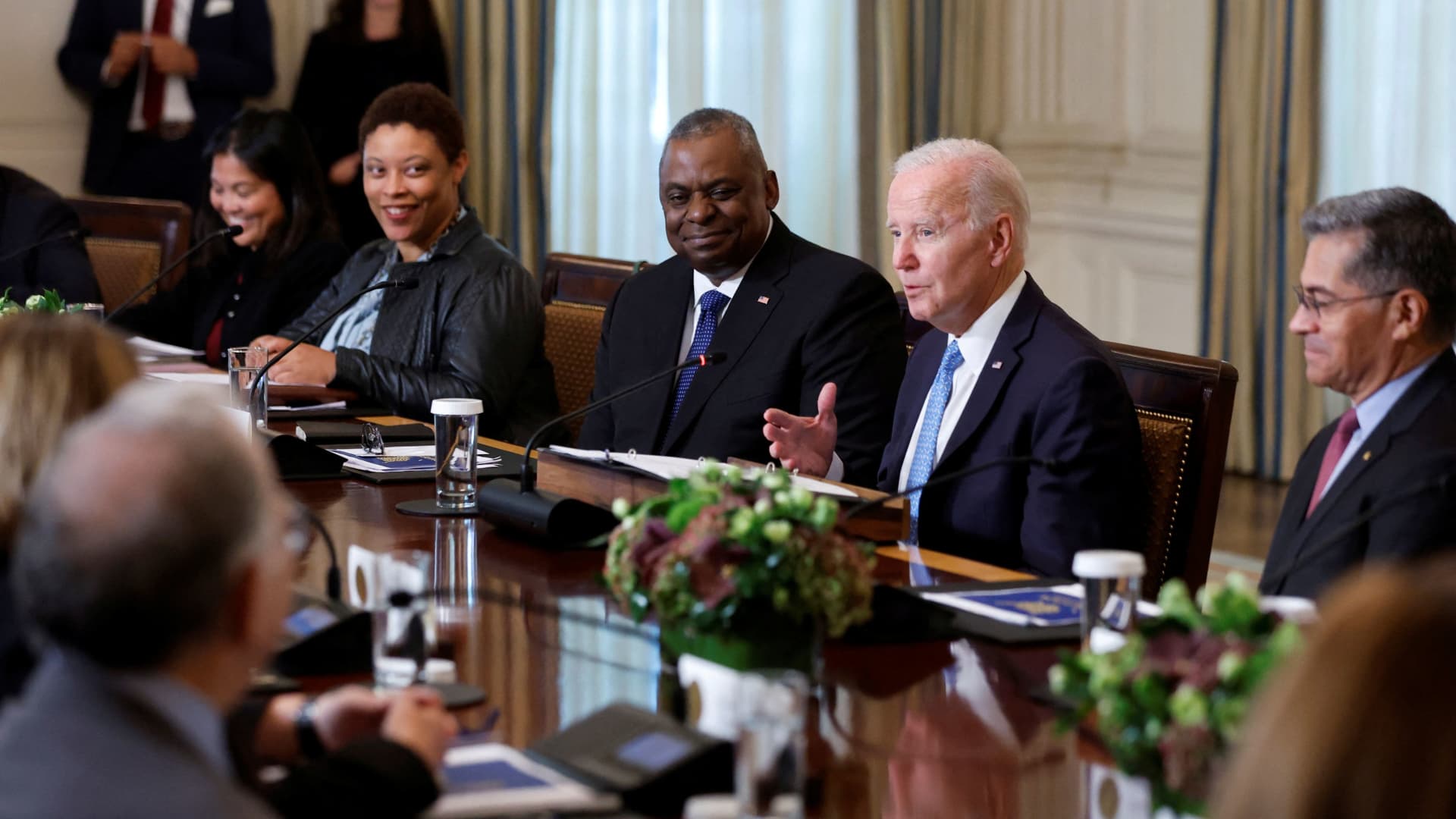 U.S. President Joe Biden, seated between Defense Secretary Lloyd Austin and Secretary of Health and Human Services (HHS) Xavier Becerra, delivers remarks at a meeting of the White House Competition Council in the State Dining Room of the White House in Washington, September 26, 2022.