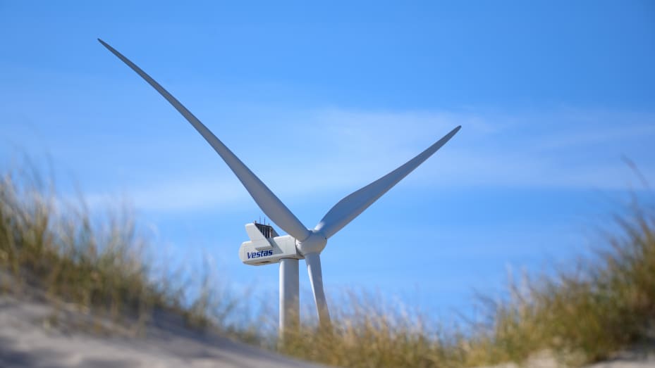 21 April 2022, Denmark, Hvide Sande: A wind turbine with the inscription "Vestas" stands against a blue sky between sand dunes near the village of Hvide Sande. Photo: Jonas Walzberg/dpa (Photo by Jonas Walzberg/picture alliance via Getty Images)