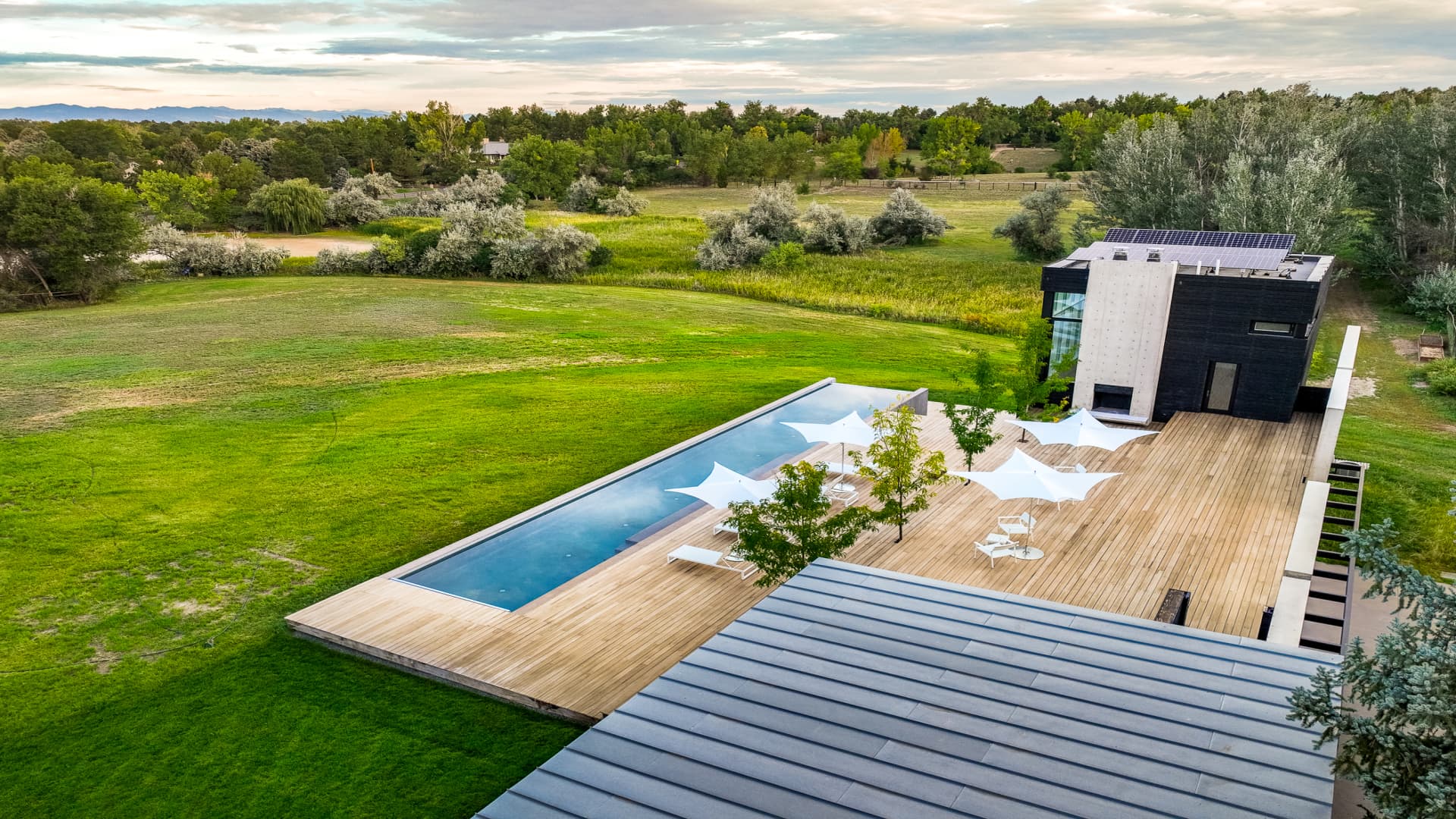 The pool and sundeck offer a view of the estate's rolling green acreage.