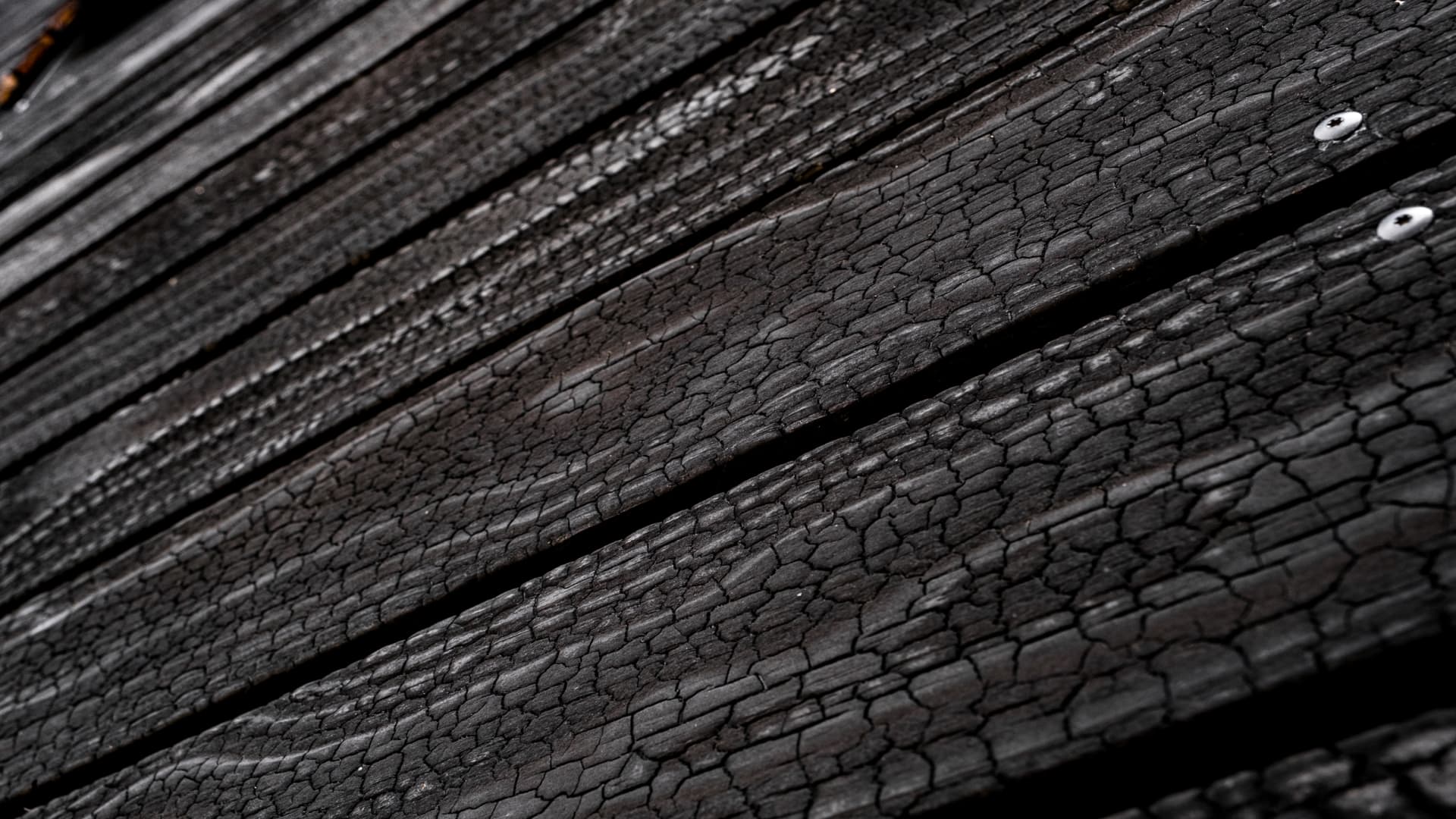 A close-up look at the unique flame-charred wood exterior of the $28,888,888 residence.