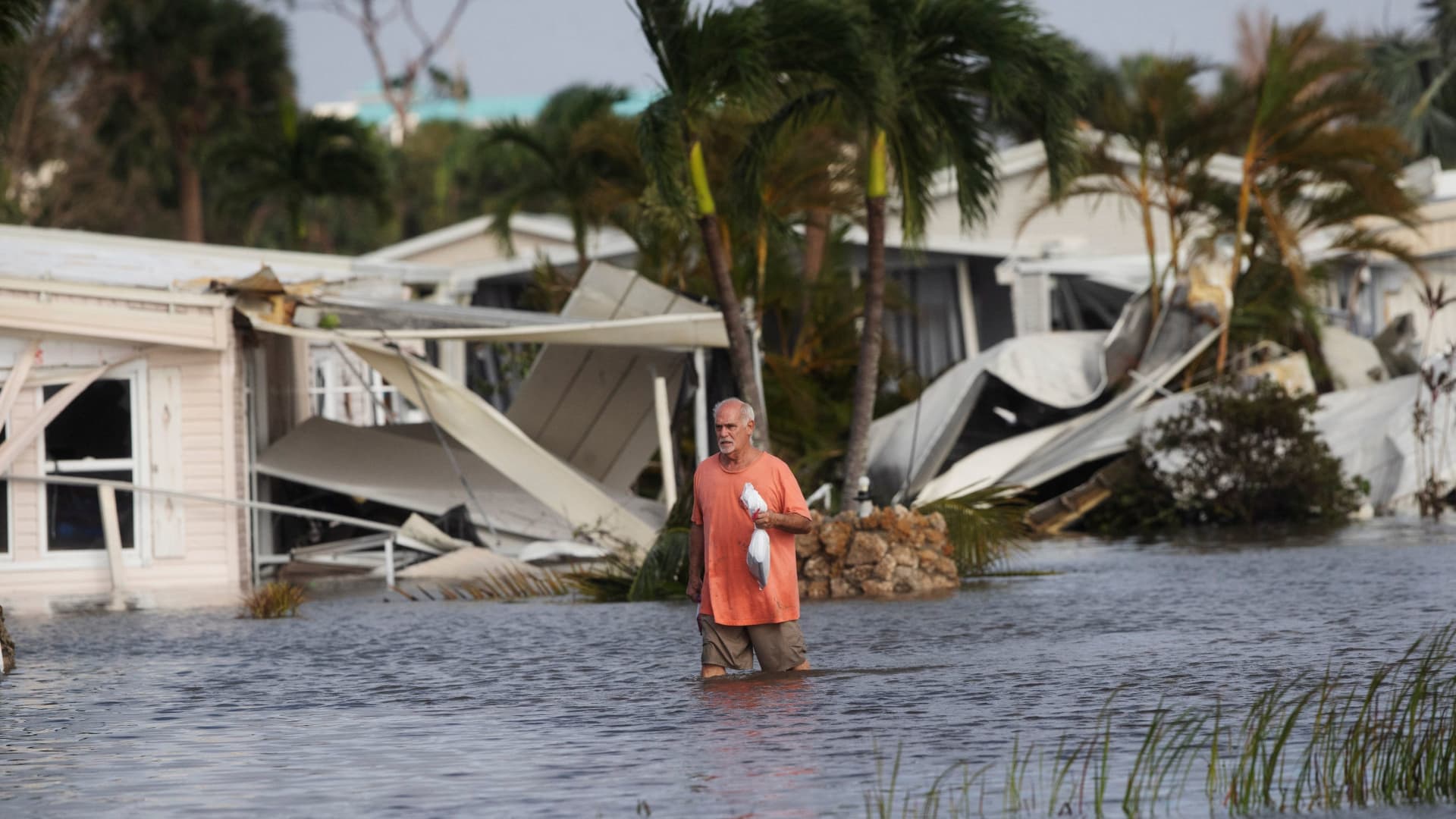 Stan Pentz walks out of a Iona neighborhood after Hurricane Ian hit Florida, September 29, 2022.