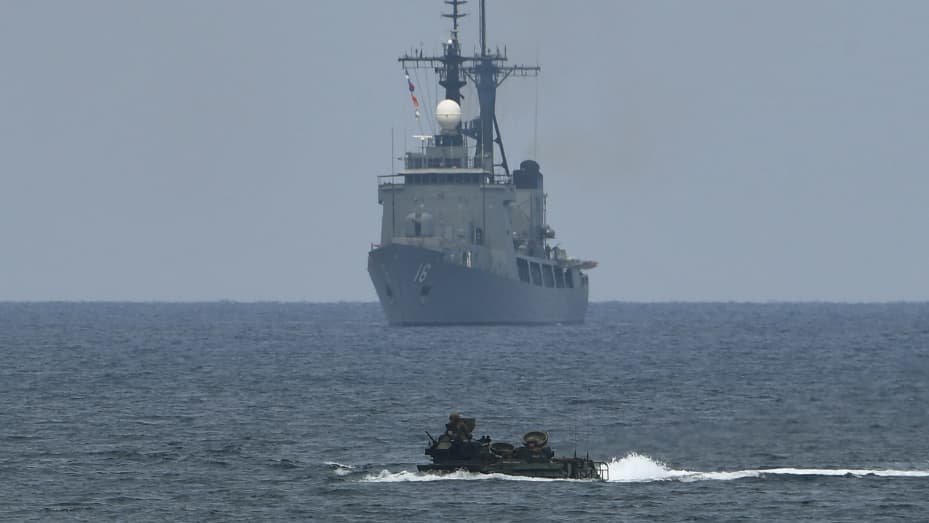 A US assault amphibious vehicle (AAV) manoeuvers past Philippine navy's frigate Ramon Alcaraz during the amphibious landing as part of the annual Philippines and US joint military exercise at the beach of Philippine navy's training camp in San Antonio, Zambales province northwest of Manila on May 9, 2018.