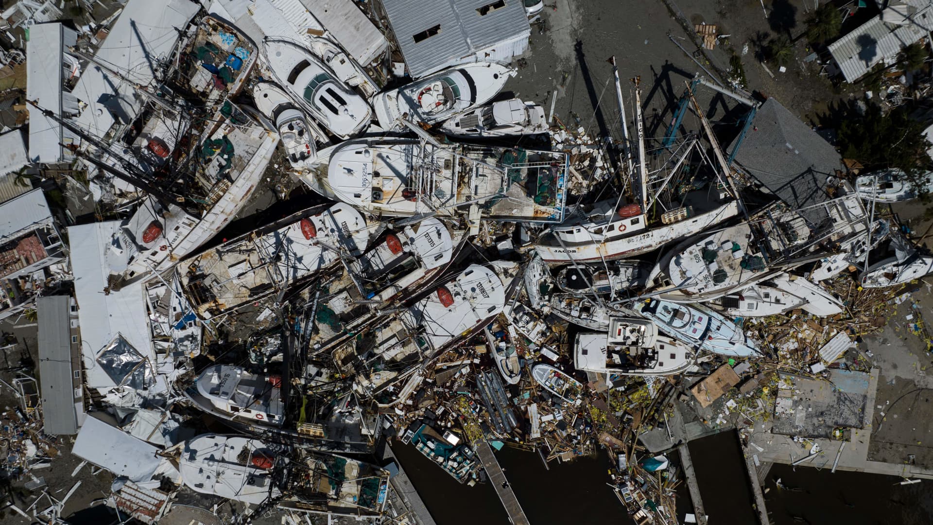 An aerial picture taken on September 29, 2022 shows piled up boats in the aftermath of Hurricane Ian in Fort Myers, Florida. 