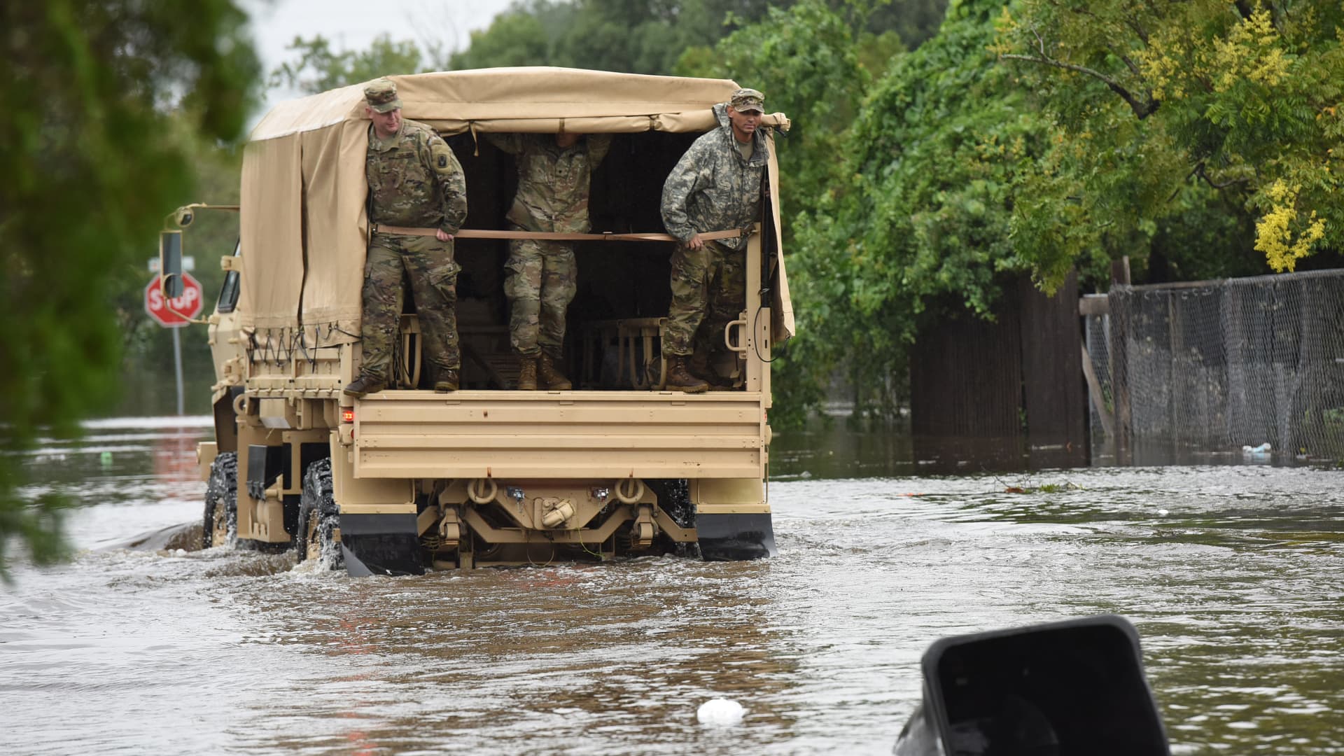 Members of the Florida National Guard look for stranded residents in a flooded neighborhood in the aftermath of Hurricane Ian on September 29, 2022 in Orlando, Florida.