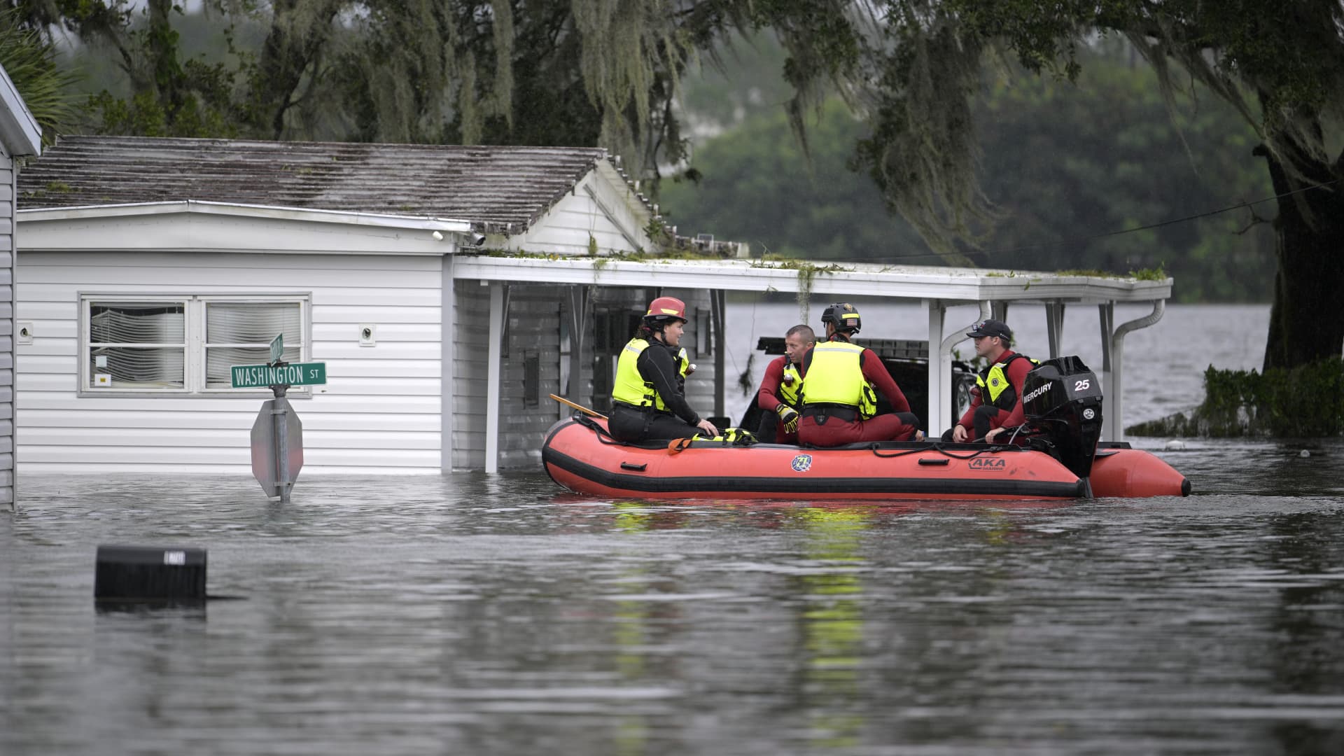 First responders with Orange County Fire Rescue check the welfare of residents as they make their way through a flooded neighborhood in the aftermath of Hurricane Ian, Thursday, Sept. 29, 2022, in Orlando, Fla.