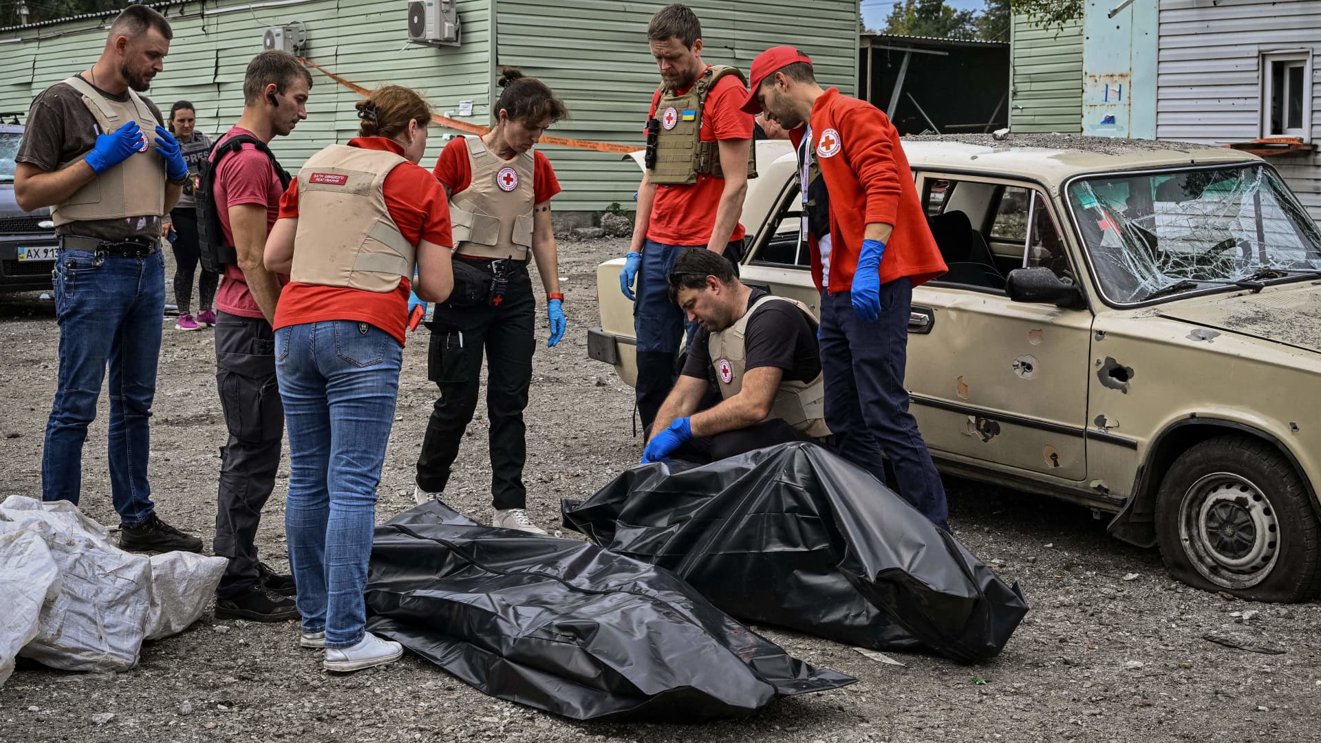 Members of the red cross checks bodies of people killed by a missile strike near Zaporizhzhia on September 30, 2022, amid the Russian invasion of Ukraine.