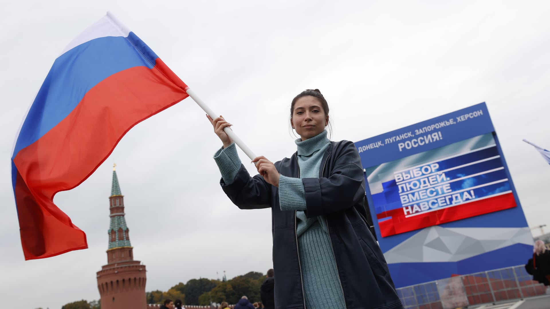 People holding Russian flags gather at Red Square during a ceremony marking the annexation of four regions of Ukraine after referendums on September 30, 2022, in Moscow, Russia.