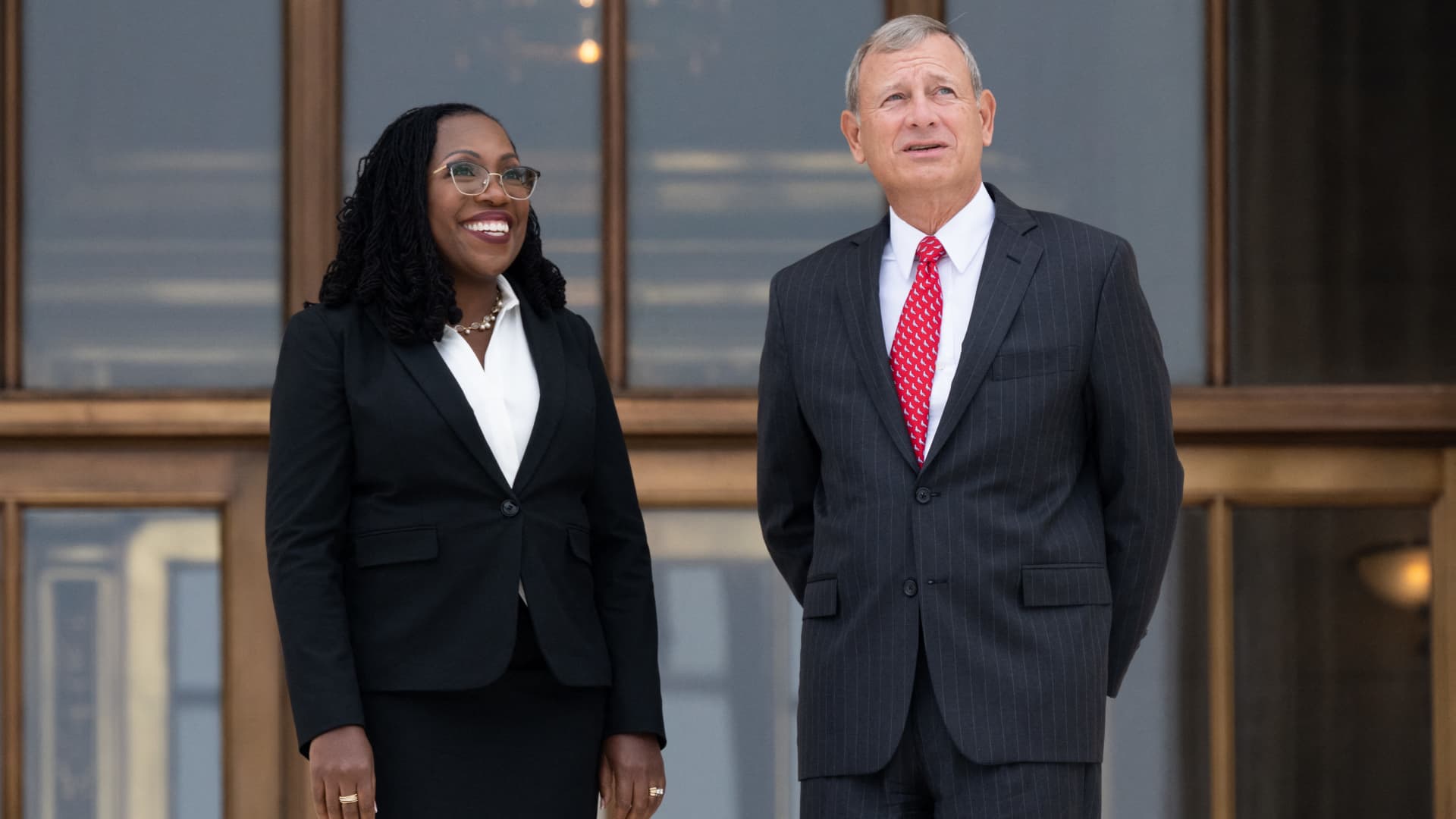 US Supreme Court Justice Ketanji Brown Jackson speaks with Chief Justice John Roberts on the steps of the US Supreme Court, immediately following the investiture ceremony of Justice Jackson, in Washington, DC, September 30, 2022.