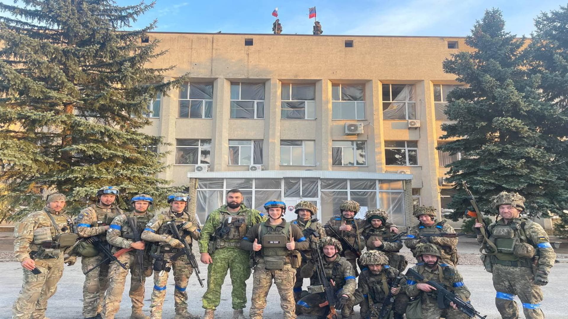 Ukrainian troops pose for a photo in Lyman, Ukraine, in this picture released on social media Oct. 1, 2022.