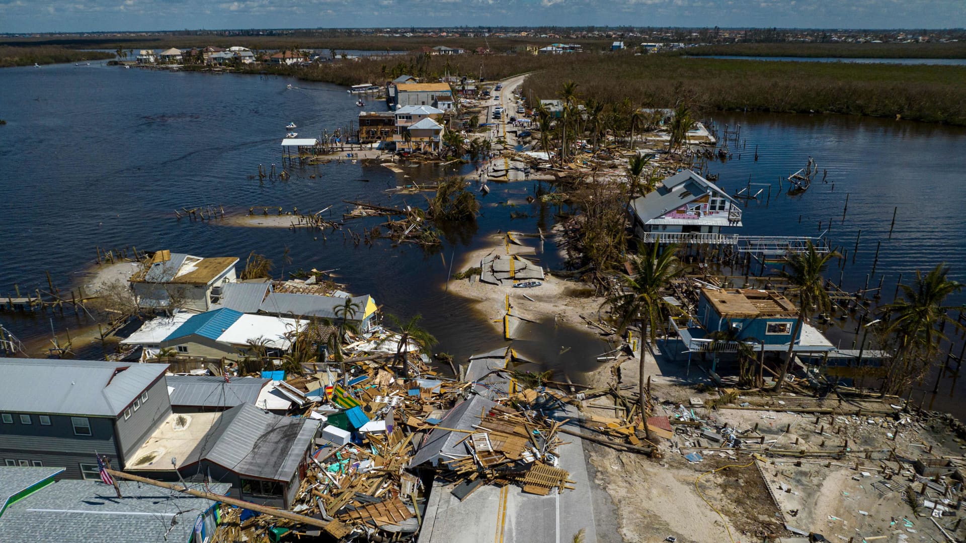 An aerial picture taken on October 1, 2022 shows a broken section of the Pine Island Road and destroyed houses in the aftermath of Hurricane Ian in Matlacha, Florida. 