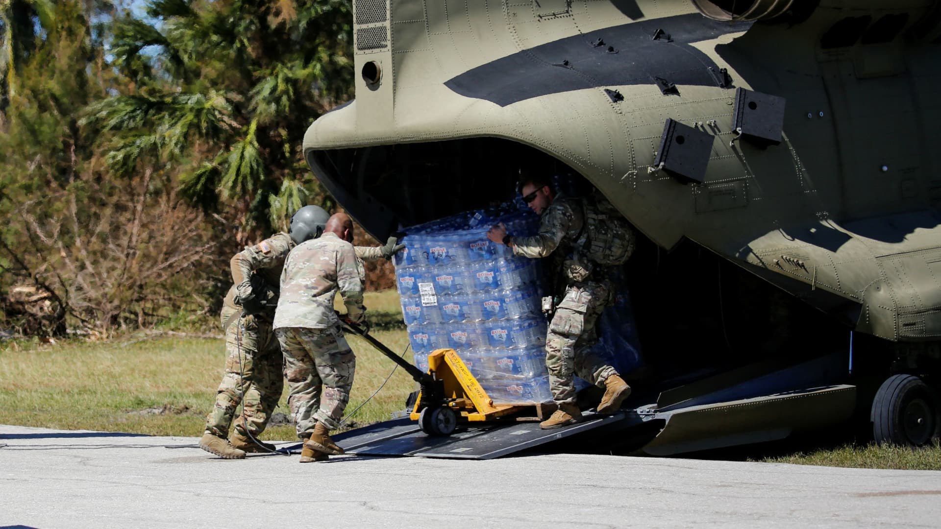 Soldiers unload water from an army helicopter near the Matlacha/Pine Island Fire Control District Station 1 after Hurricane Ian caused widespread destruction in Pine Island, Florida, U.S., October 2, 2022. 