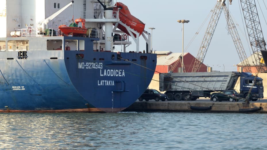 A picture shows a view of the stern of the grain-laden Syrian-flagged ship Laodicea, docked in Lebanon's northern port of Tripoli, on July 30, 2022. A Lebanese prosecutor ordered "the seizure of the ship until the investigation is completed", instructing the police to consult the Ukraine embassy after it claimed that the grain cargo was loaded from a region occupied by Russian forces.