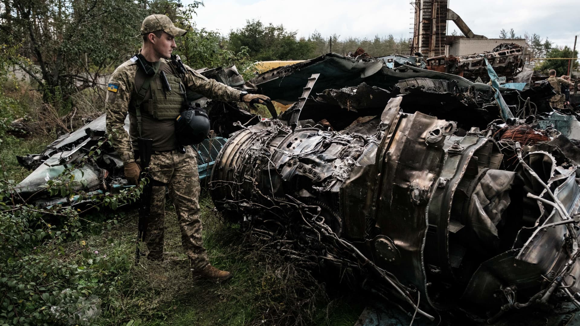 A Ukrainian army press officer shows the debris of Russian air strike aircraft Su-34 at a collection point of destroyed Russian armored vehicles at an animal feed plant in the recently retaken town of Lyman in the Donetsk region, on Oct. 5, 2022.