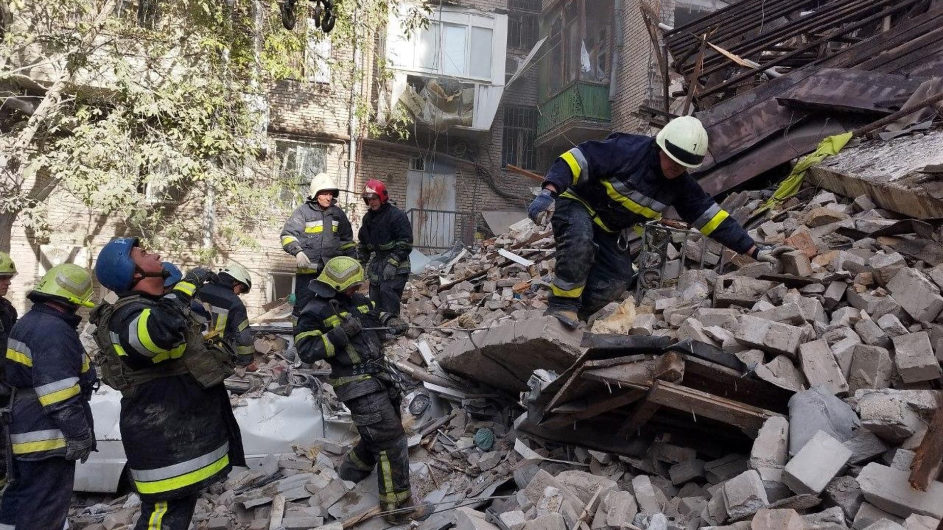 Ukrainian firefighters clear debris after a strike on Zaporizhzhia on October 6, 2022.