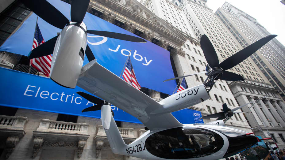A Joby Aviation Inc. Electric Vertical Take-Off and Landing (eVTOL) aircraft outside the New York Stock Exchange (NYSE) during the company's initial public offering in New York, U.S., on Wednesday, Aug. 11, 2021. Joby Aviation, which promises to build and operate a commercial fleet of aerial taxis by 2024, began trading Wednesday, testing the imaginations of public investors. The shares surged more than 12% during the first hour of trading. Photographer: Michael Nagle/Bloomberg via Getty Images