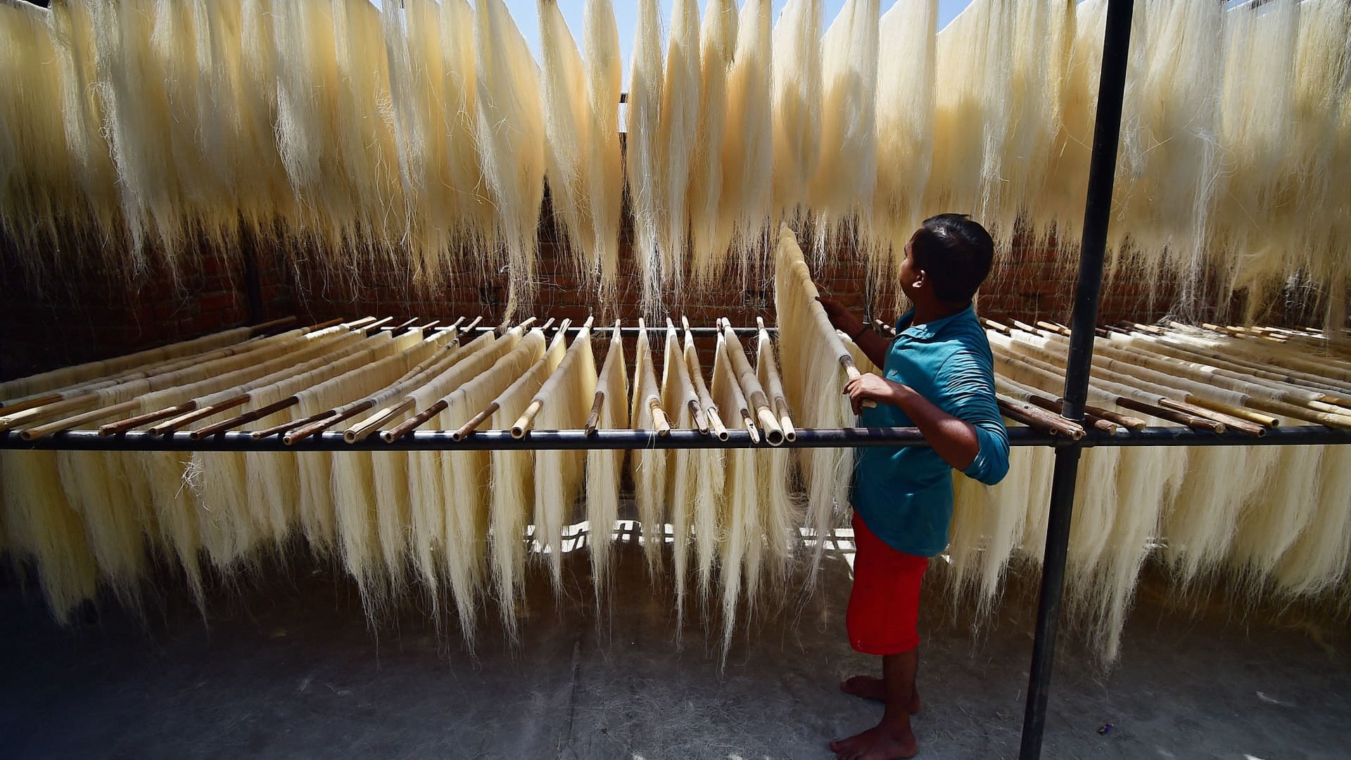 A worker preparing vermicelli, which is used in a traditional sweet dish popularly consumed during the holy month of Ramadan at a factory in Allahabad on April 13, 2021.
