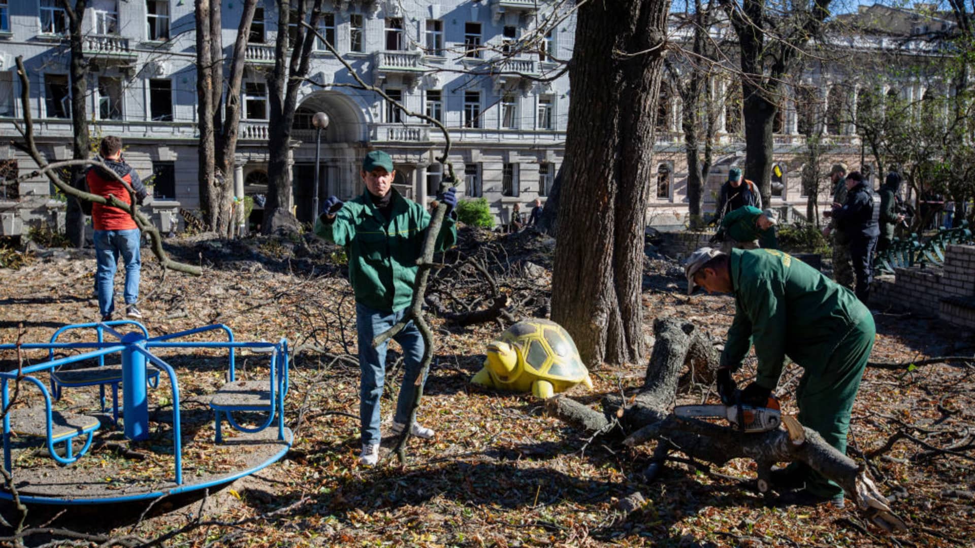 Municipal workers clear a damaged playground after a Russian missile attack in central Kyiv.