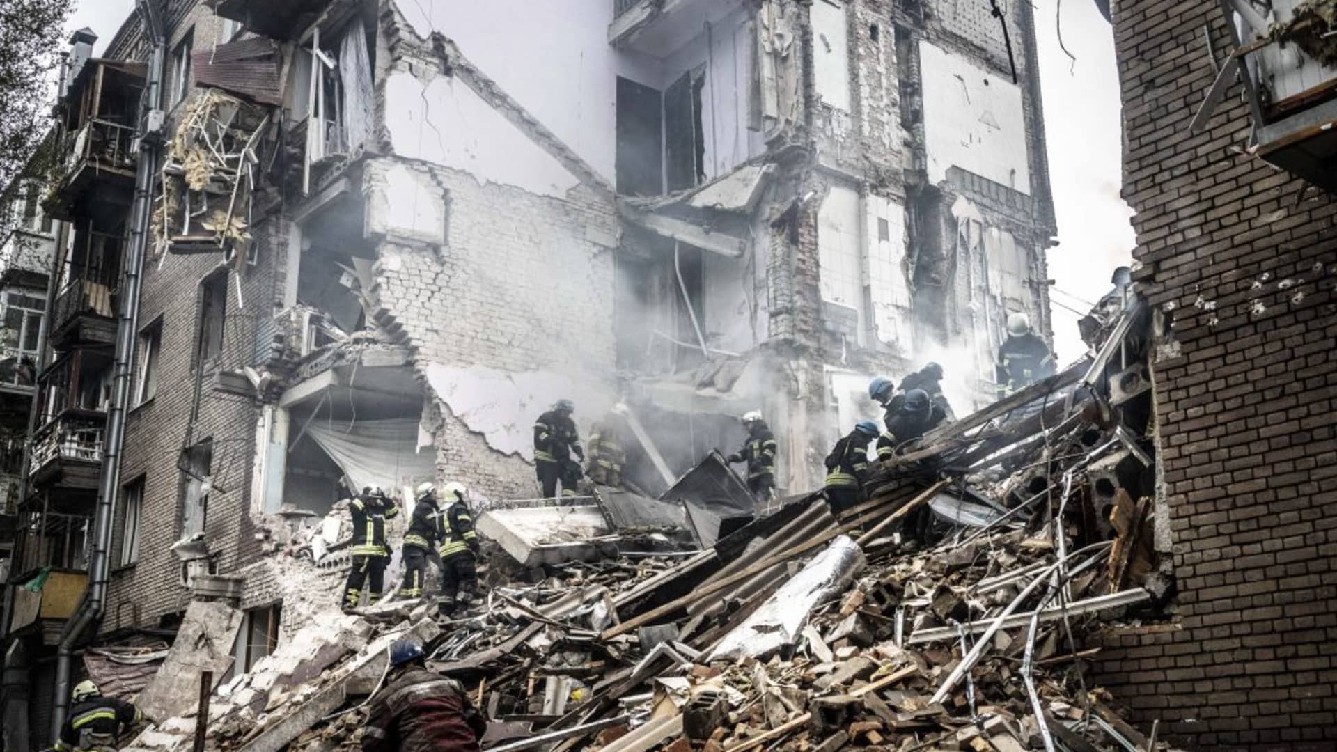 Firefighters in a damaged building after a Russian missile attack in Zaporizhzhia, Ukraine, on Oct. 10, 2022.