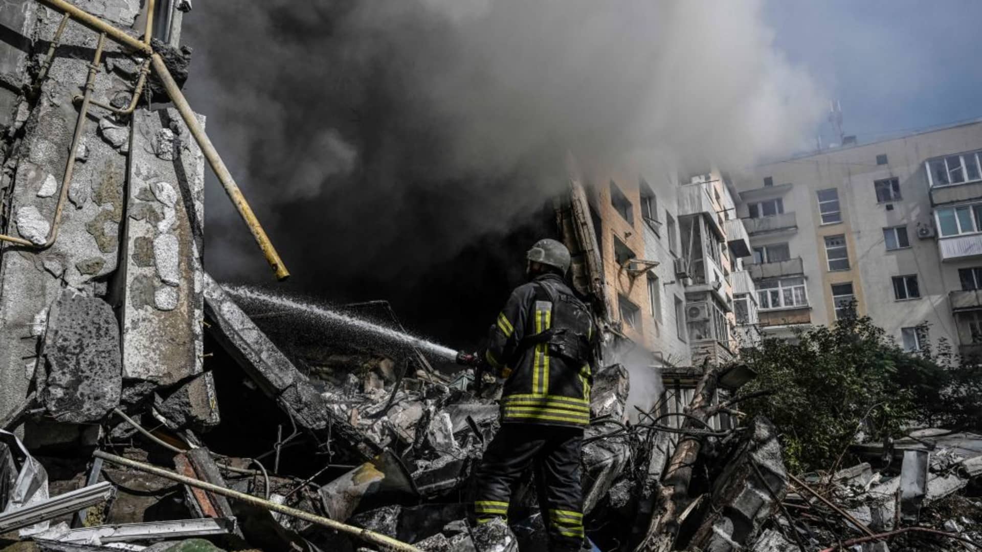 A firefighter extinguishes a fire after a flat was hit by a missile strike in Bakhmut, Donetsk region, on Sept. 15, 2022.