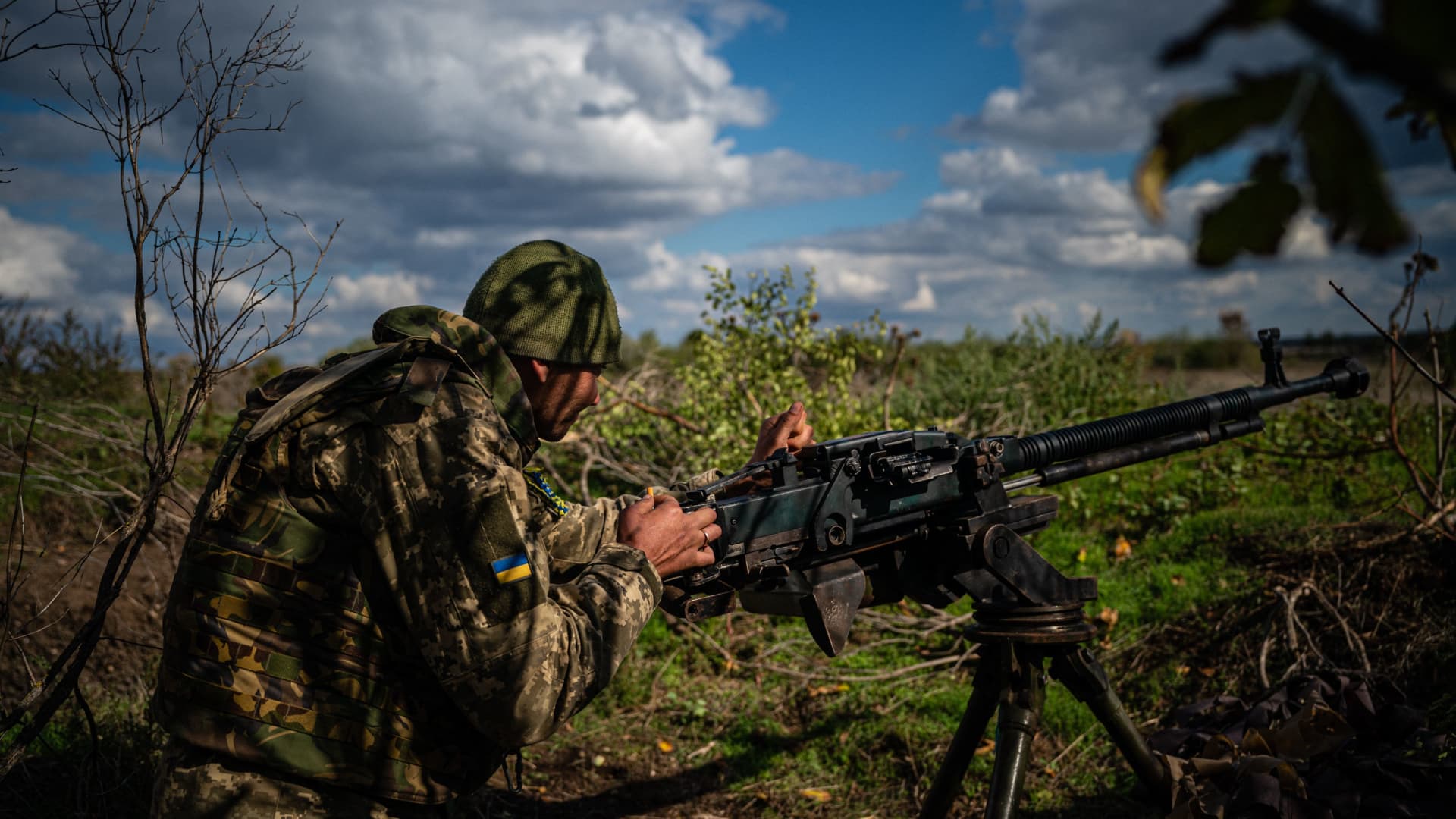 Ukrainian soldier Viktor, 35, checks his heavy machine gun at a position along the front line in the Mykolaiv region on October 5, 2022, amid the Russian invasion of Ukraine.