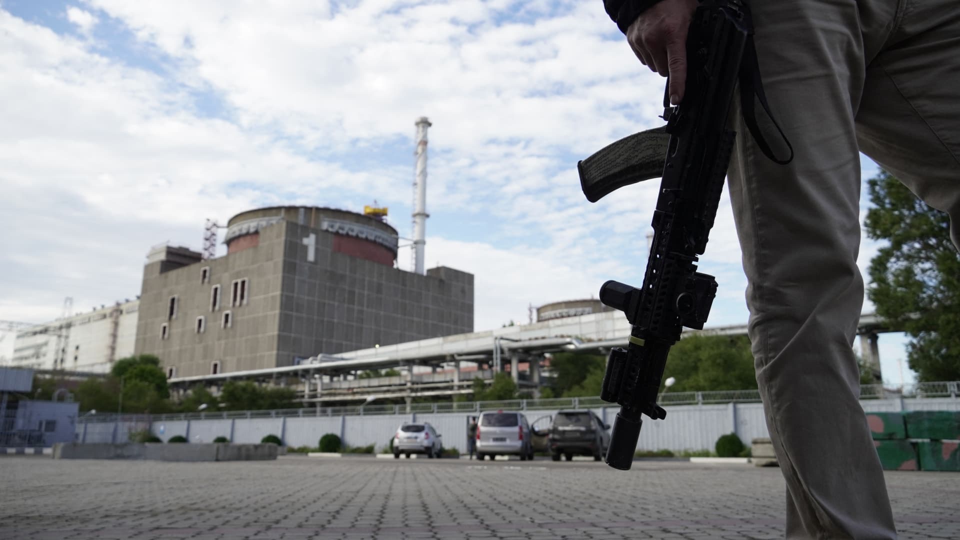 This photo taken on Sept. 11, 2022, shows a security person standing in front of the Zaporizhzhia Nuclear Power Plant in Enerhodar, Zaporizhzhia, amid the Ukraine war.