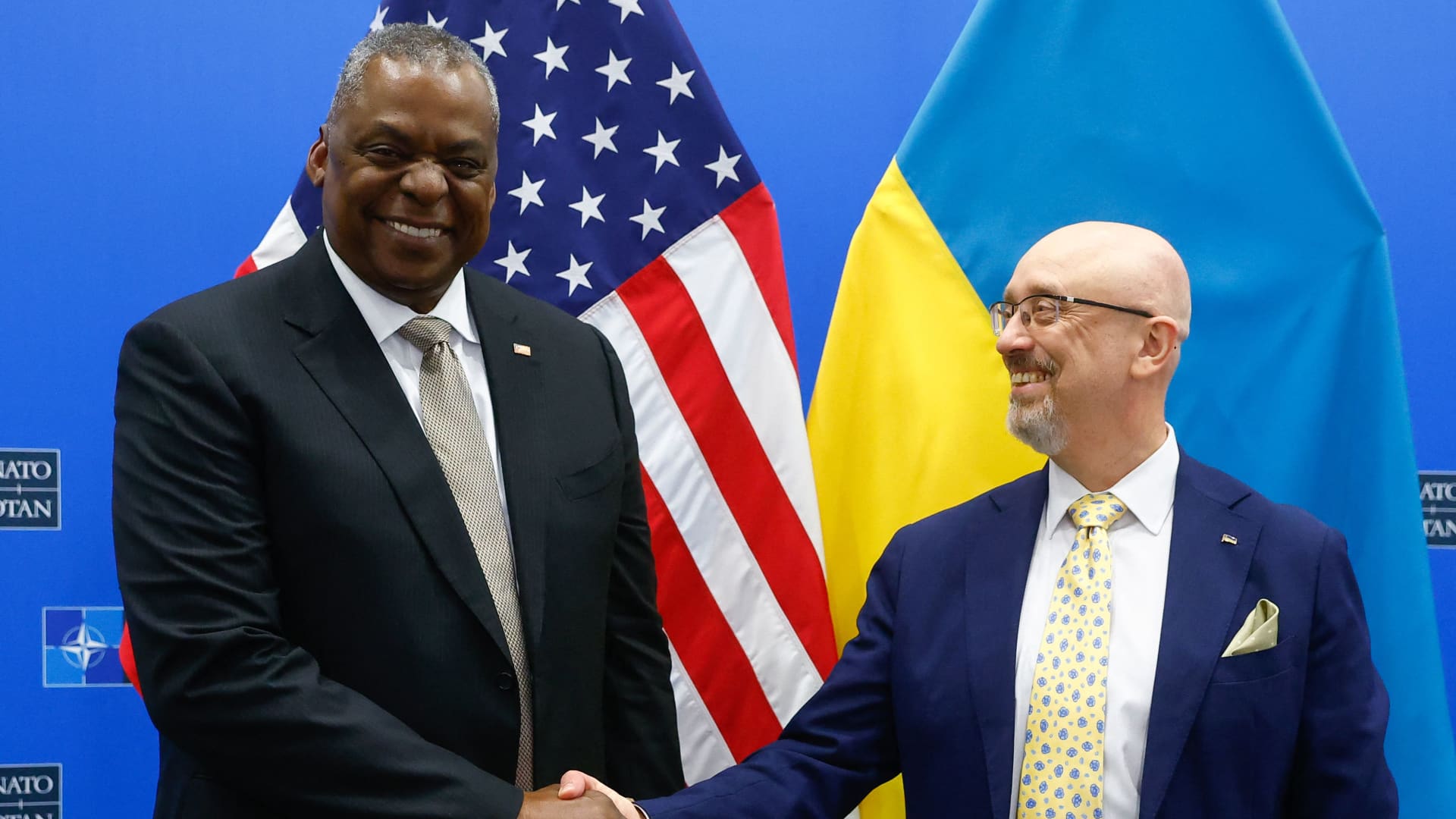 US Defence Secretary Lloyd Austin (L) shakes hand with Ukraine's Defence minister Oleksiy Reznikov (R) ahead of a meeting of the Ukraine Defence contact group as part of a NATO Defence Ministers Council at the Alliance headquarters in Brussels on October 12, 2022.