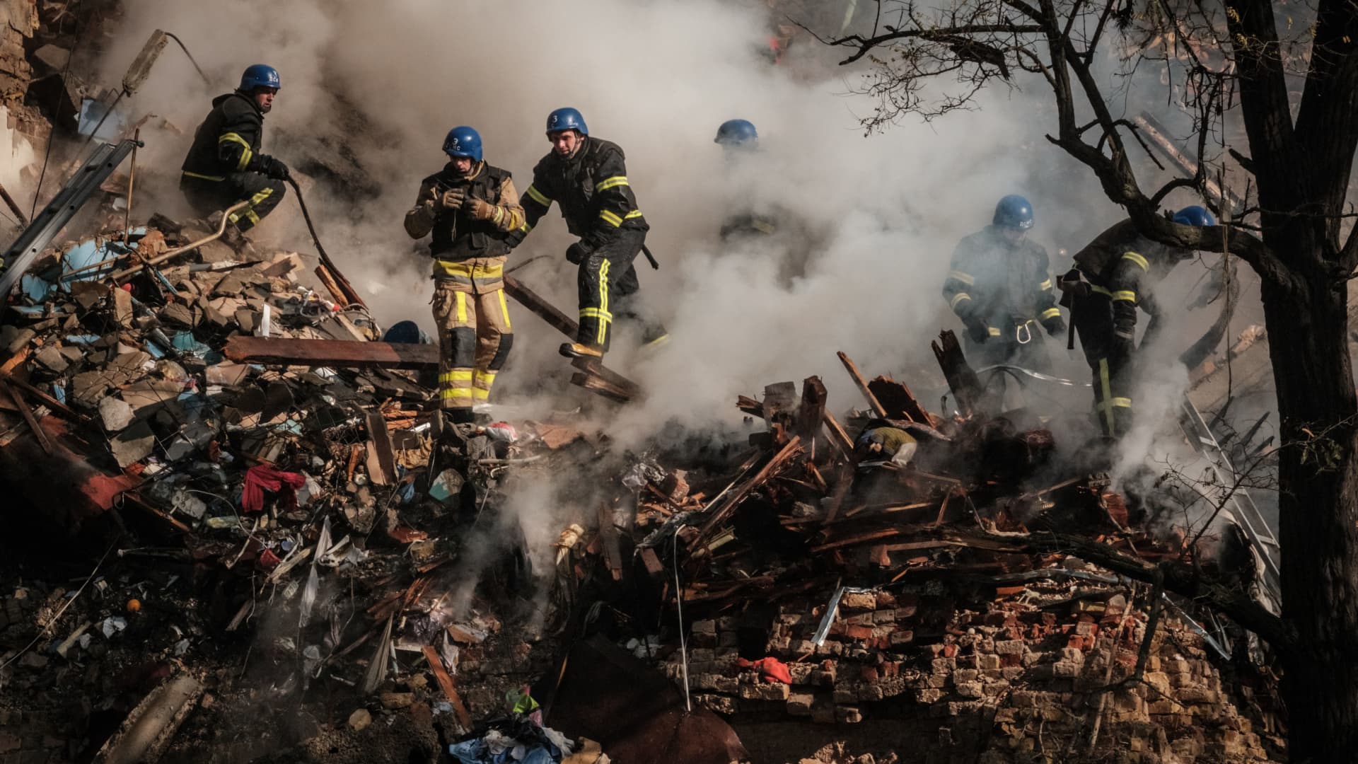 Ukrainian firefighters work on a destroyed building after a drone attack in Kyiv on Oct. 17, 2022, amid the Russian invasion of Ukraine.