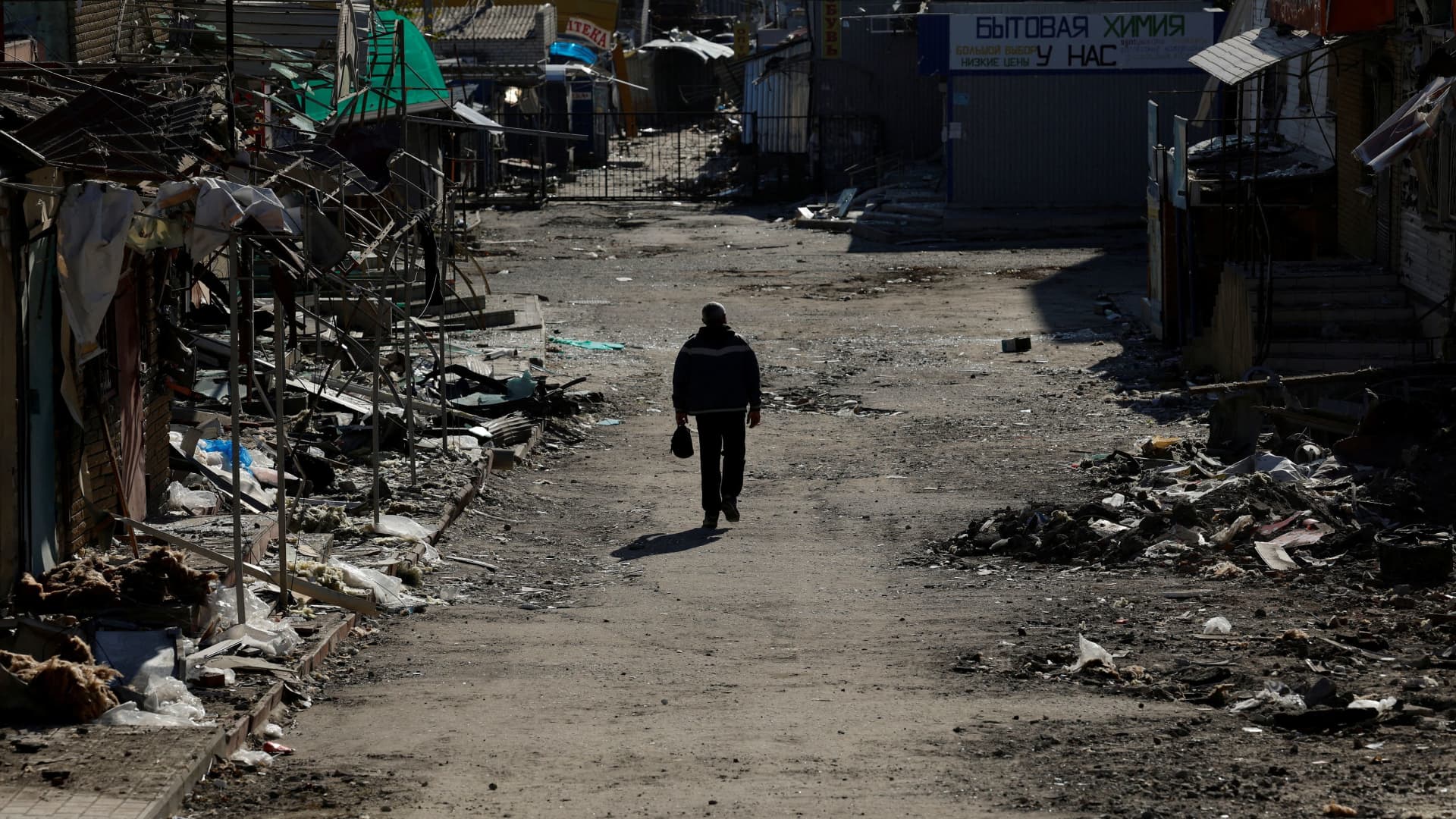 A man walks through a shopping street destroyed by Russian strikes, amid Russia's attack on Ukraine, in the recently retaken town of Kupiansk, Ukraine, October 18, 2022.