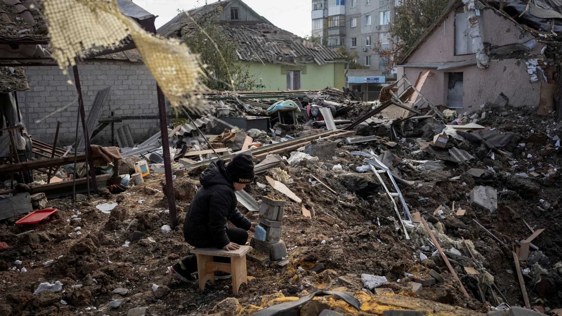 A boy plays on ruins of his grandmother's house, amid Russia's attack on Ukraine, in Kupiansk, Ukraine October 16, 2022.