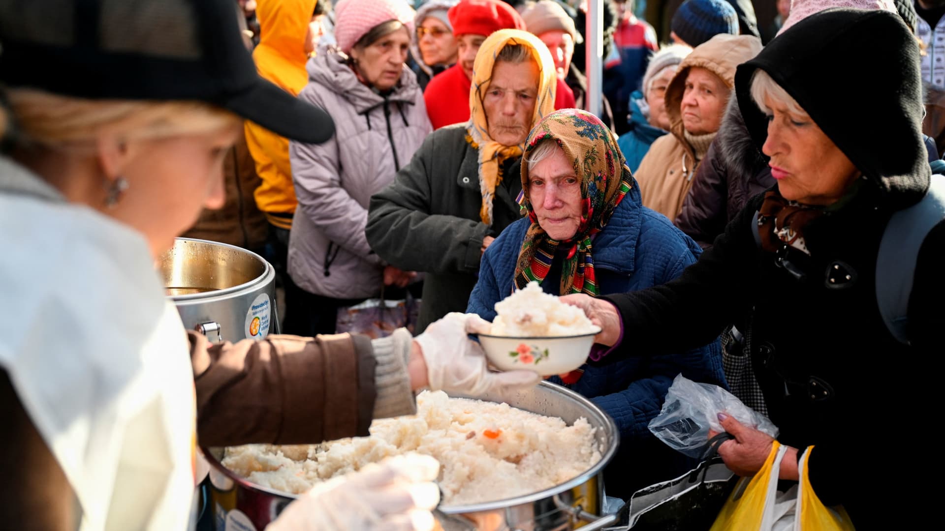 Local residents line up to receive a meal provided by the World Central Kitchen NGO, amid Russia's invasion of Ukraine, in the town of Kupiansk in Kharkiv region, Ukraine October 14, 2022.
