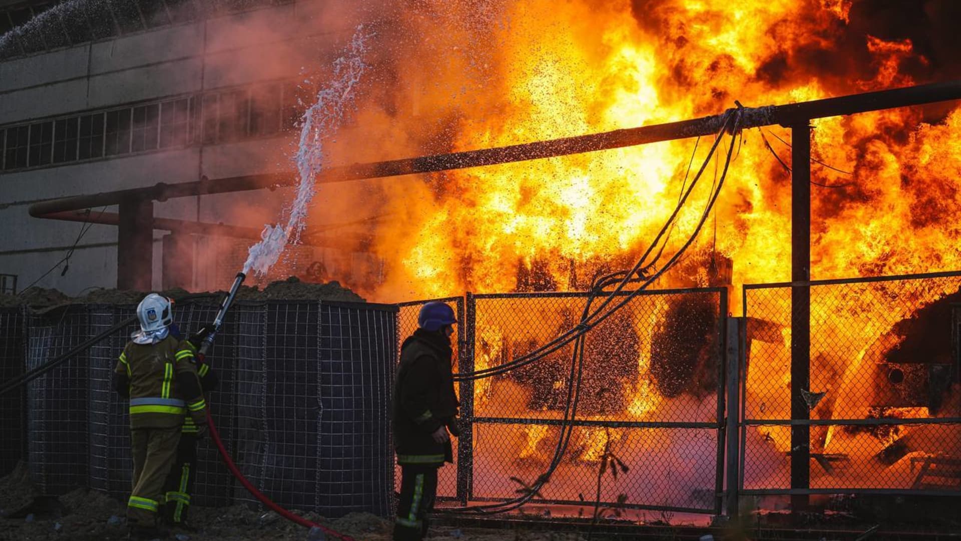 Members of emergency services respond to a fire after a Russian attack targeted energy infrastructure in Kyiv, Ukraine on Oct. 18, 2022.