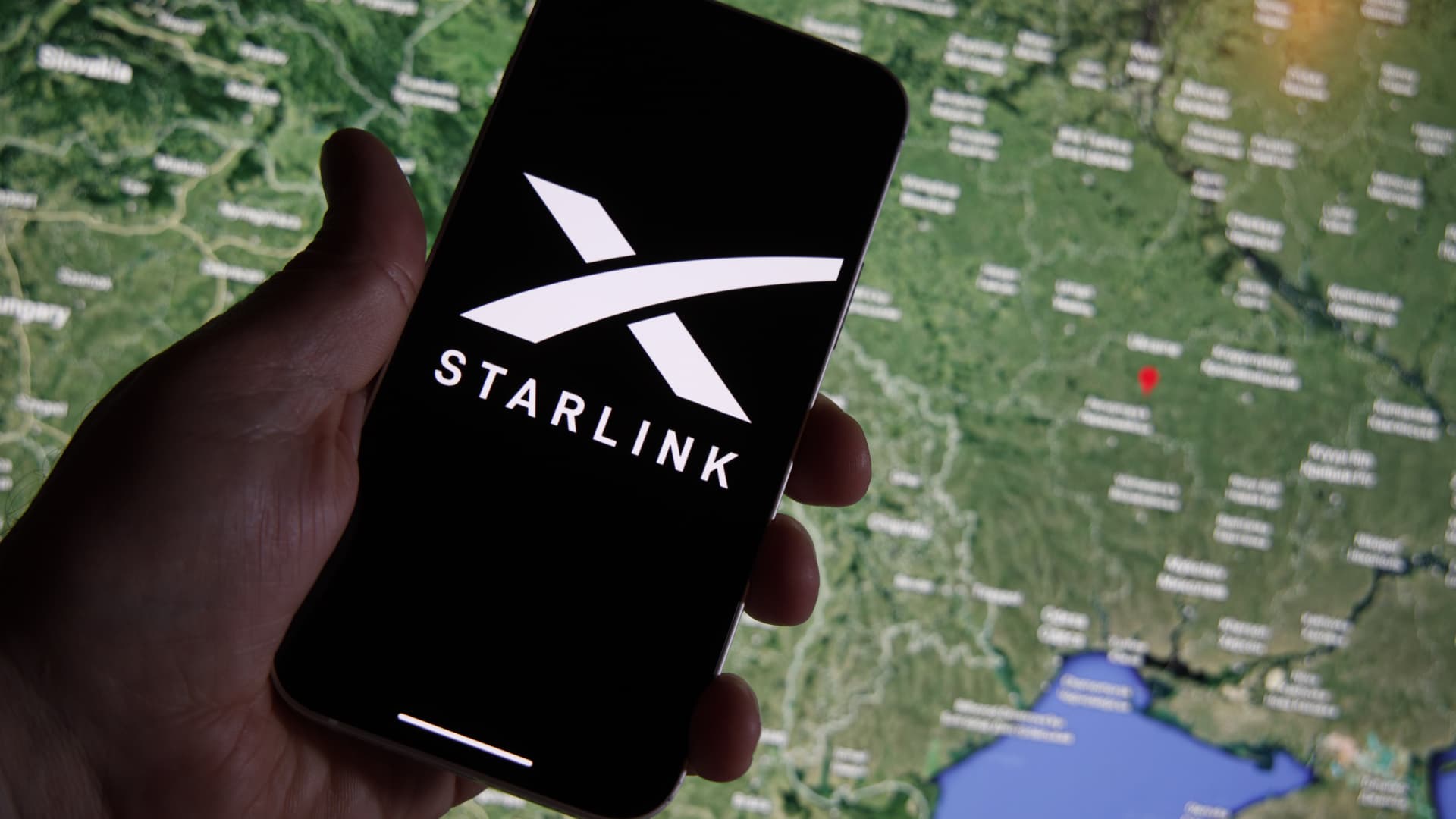 The Starlink photo is seen on a mobile device with Ukraine on a map in the background in this illustration photo in Warsaw, Poland on 21 September, 2022.