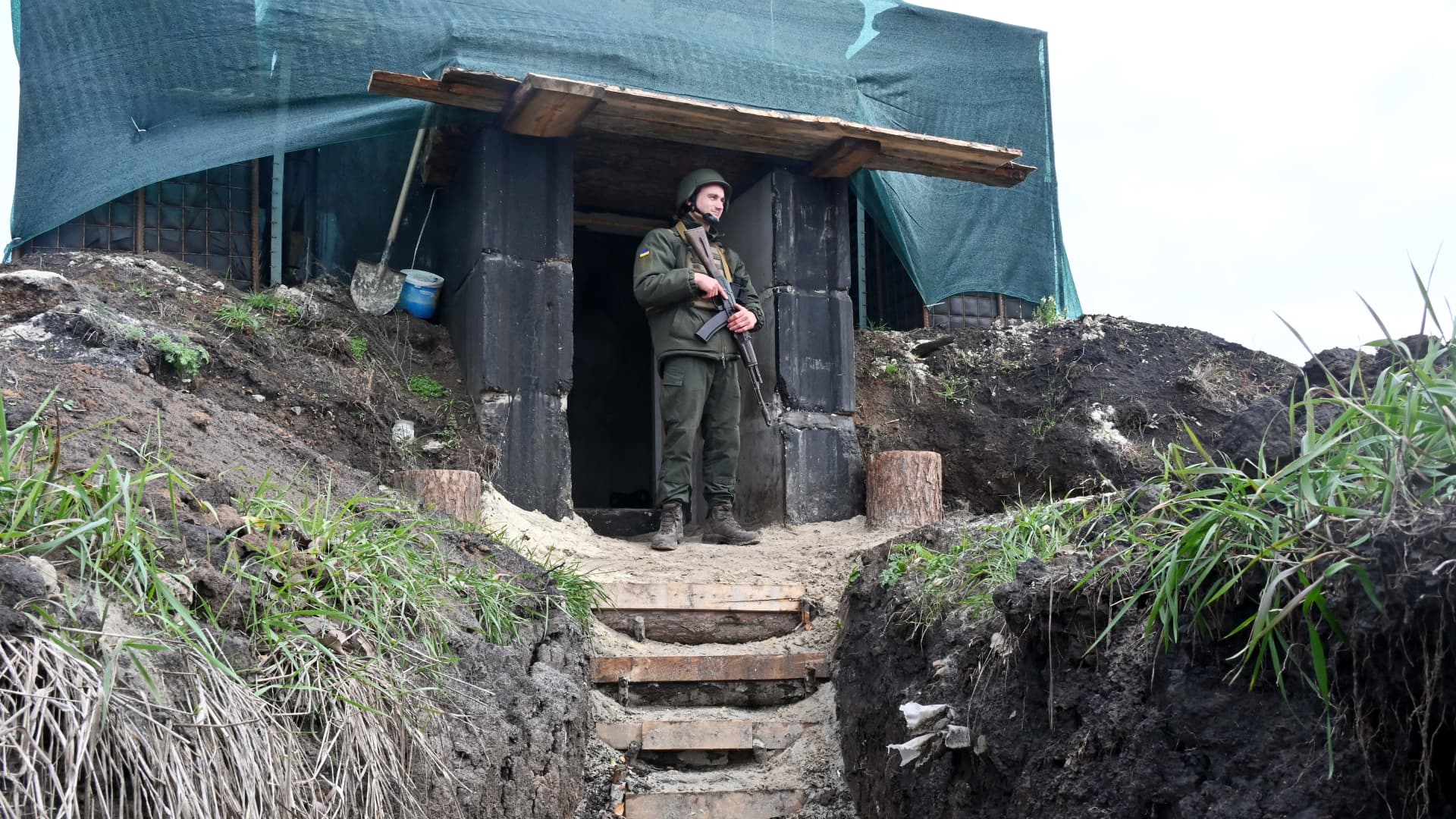 A soldier of the National Guard of Ukraine stands at the entrance of a dugout in the northern occupied territories of Kharkiv region on October 21, 2022, amid the Russian military invasion of Ukraine.