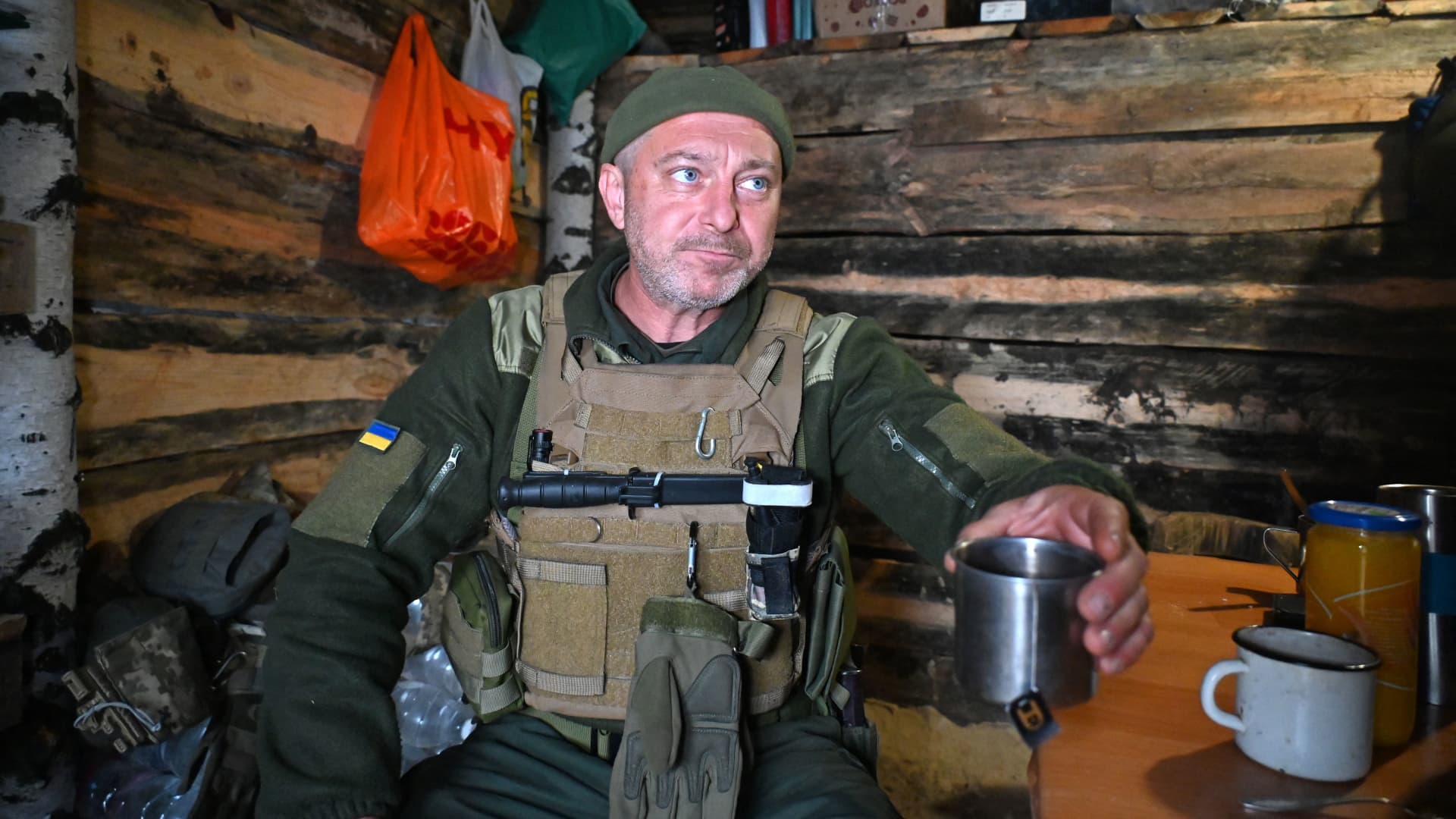 A soldier of the National Guard of Ukraine drinks tea in a dugout in the northern occupied territories of Kharkiv region on October 21, 2022, amid the Russian military invasion of Ukraine.
