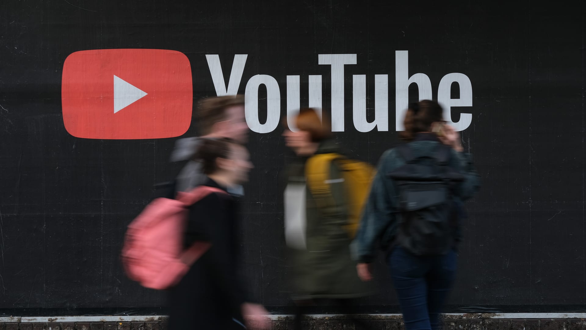 People walk past a billboard advertisement for YouTube on September 27, 2019 in Berlin, Germany.