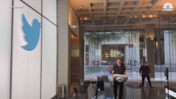 Billionaire Elon Musk walks into Twitter headquarters, sink in hand