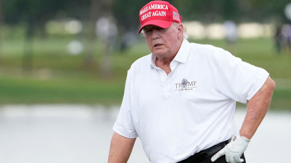 Oct 27, 2022; Miami, Florida, USA; Former President Donald Trump stands on the 18th green during the Pro-Am tournament before the LIV Golf series at Trump National Doral. Mandatory Credit: Jasen Vinlove-USA TODAY Sports