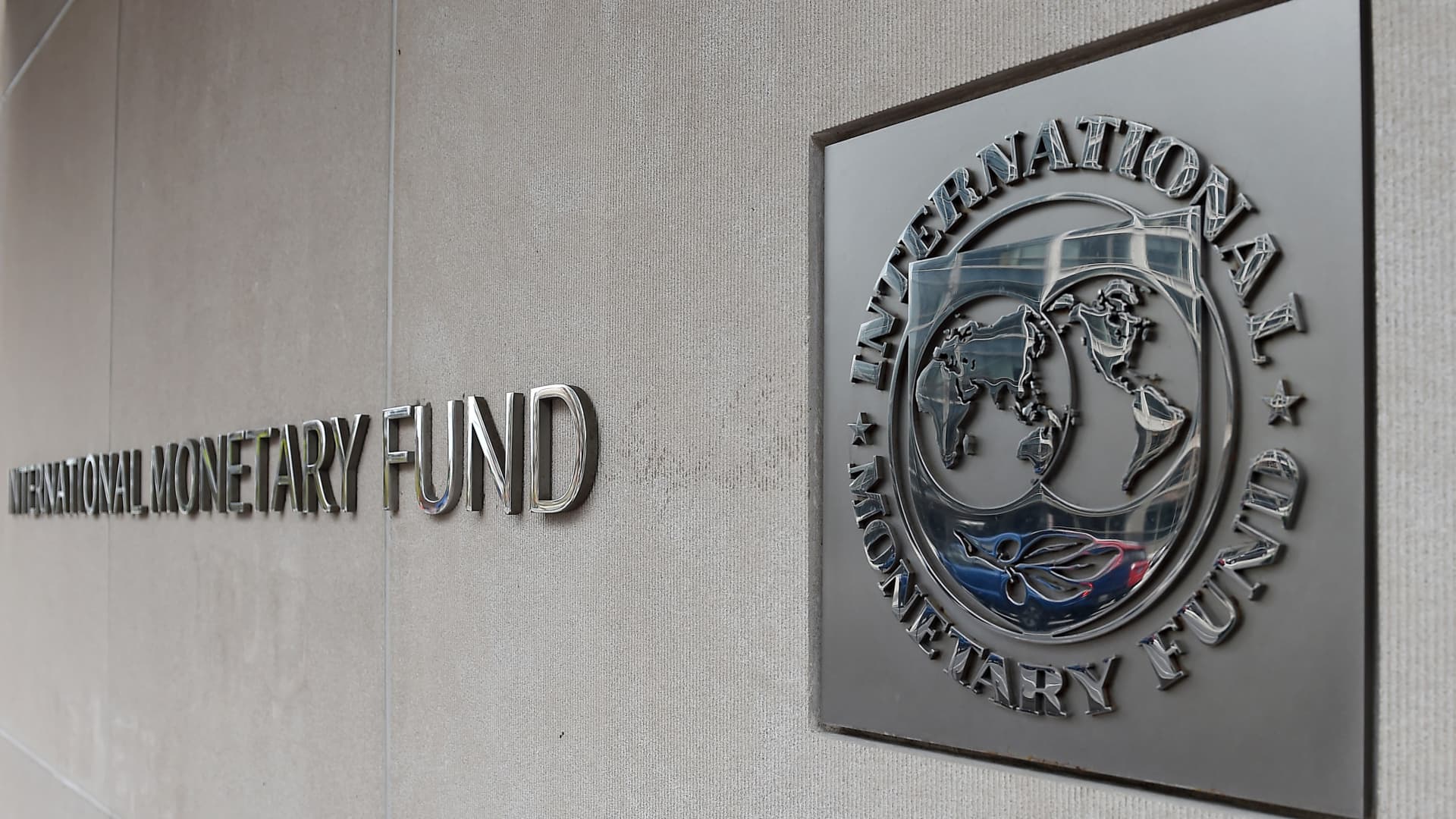 An exterior view of the building of the International Monetary Fund (IMF), with the logo, is seen on March 27, 2020 in Washington, D.C.
