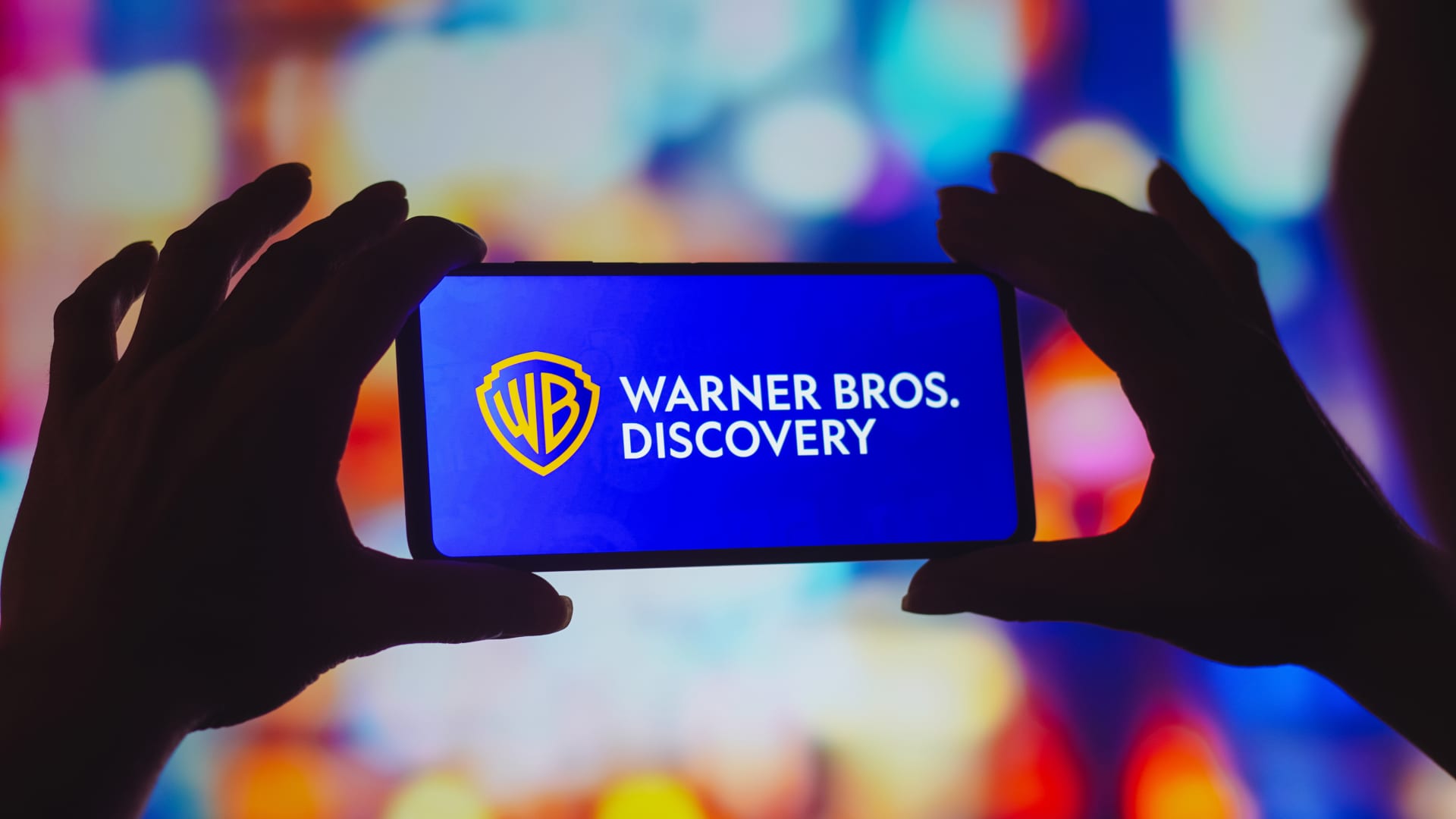 In this photo illustration, the Warner Bros. Discovery logo is displayed on a smartphone screen.