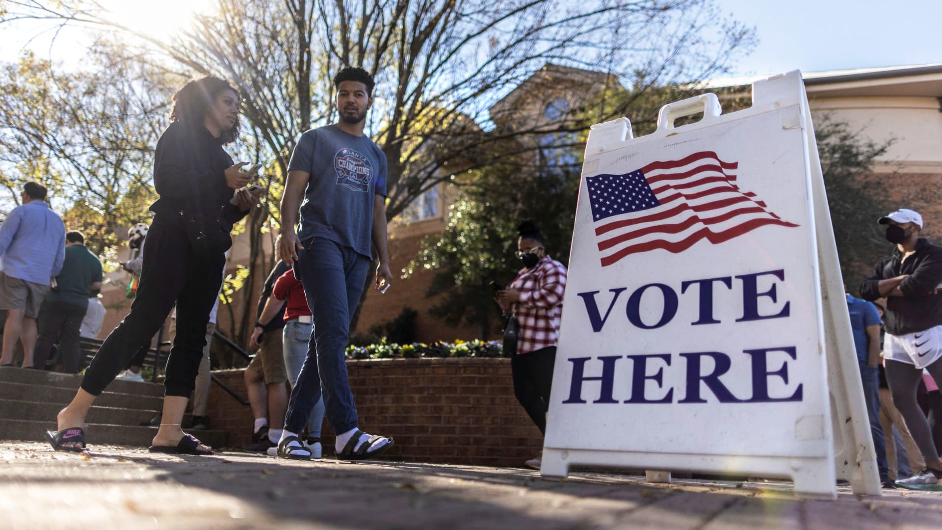 A couple leave after casting their ballots during early voting for the midterm elections at the Smyrna Community Center in Smyrna, Georgia, November 4, 2022.