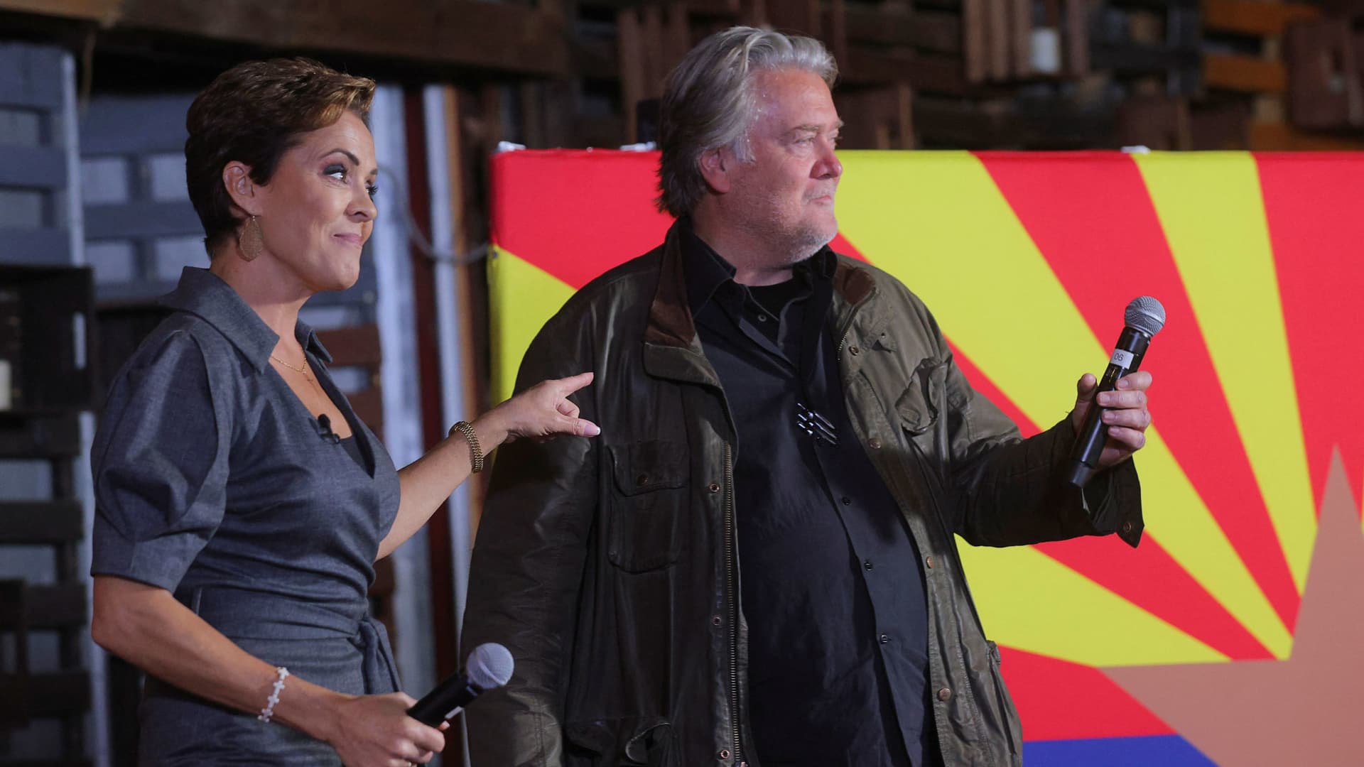 Republican candidate for Arizona Governor Kari Lake is joined onstage by Steve Bannon, former advisor to U.S. President Donald Trump, during a campaign stop on the Arizona First GOTVBus Tour in Queen Creek, Arizona, U.S., November 6, 2022. 