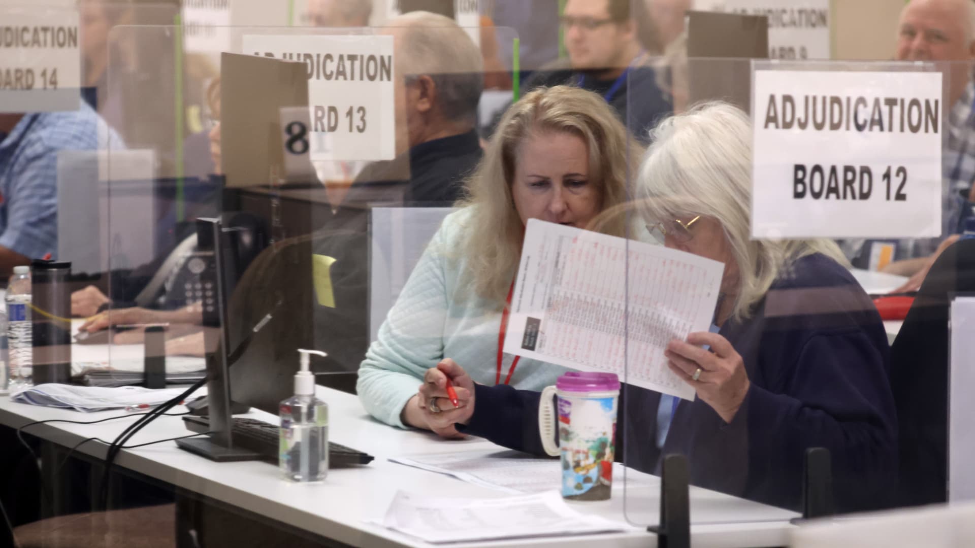 An adjudication board reviews ballots at the Maricopa County Tabulation and Election Center on November 07, 2022 in Phoenix, Arizona.