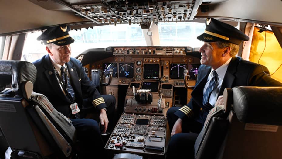 DENVER, CO - OCTOBER 26: United Airlines pilots Capt. Tom Spratt, left, and Dean McDavid in the cockpit of the iconic Boeing 747 parked at the United's B-concourse at Denver International Airport October 26, 2017. United's Boeing 747 fleet is retiring from scheduled service November 7, 2017 and will be replaced with more fuel-efficient, cost-effective wide body aircraft for long-haul flights around the world. United held a farewell event, Queen of the Skies for United employees which included tours of the a