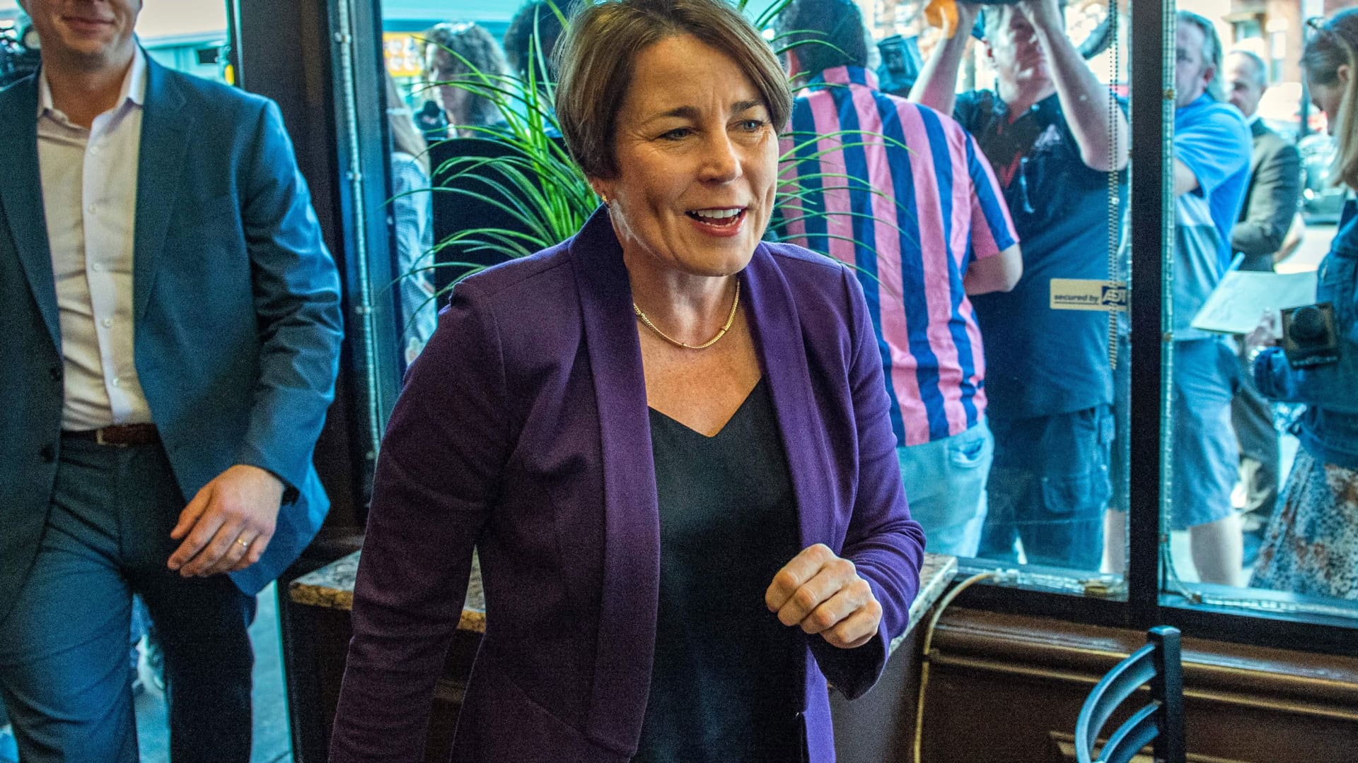 Democrat Gubernatorial nominee Maura Healey (R) visits Meridian Street Market as she campaigns on the eve of the US midterm elections, in Boston, Massachusetts, on November 7, 2022.