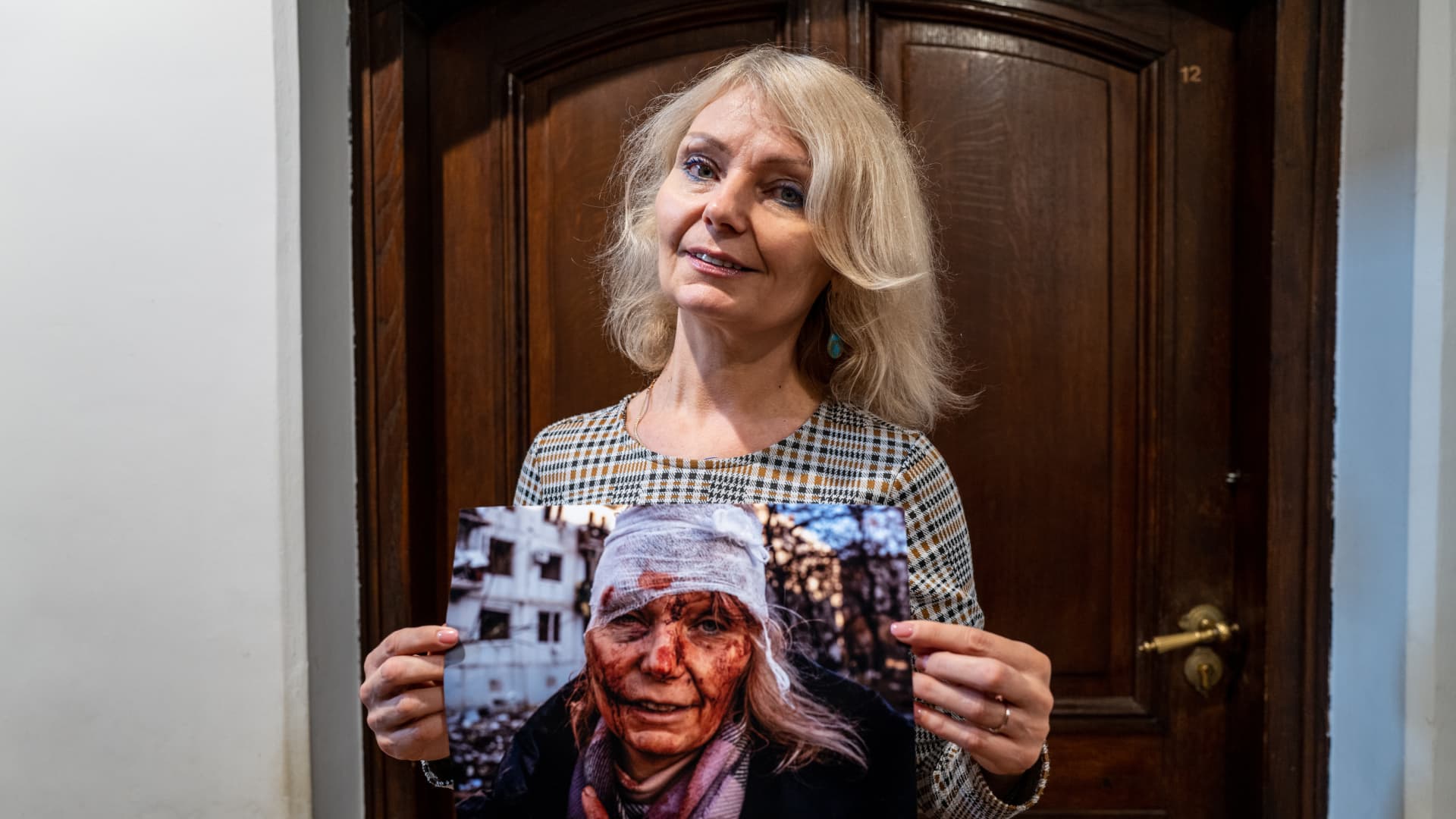Ukrainian teacher Olena Kurilo, who has become the symbol of the Russia-Ukraine war with her iconic photo -- her head wrapped in a bandage, her face caked with blood after the airstrike -- that Anadolu Agency photojournalist Wolfgang Schwan took on Feb. 24, poses with her iconic photo during an exclusive interview for Anadolu Agency in Warsaw, Poland on November 09, 2022. 