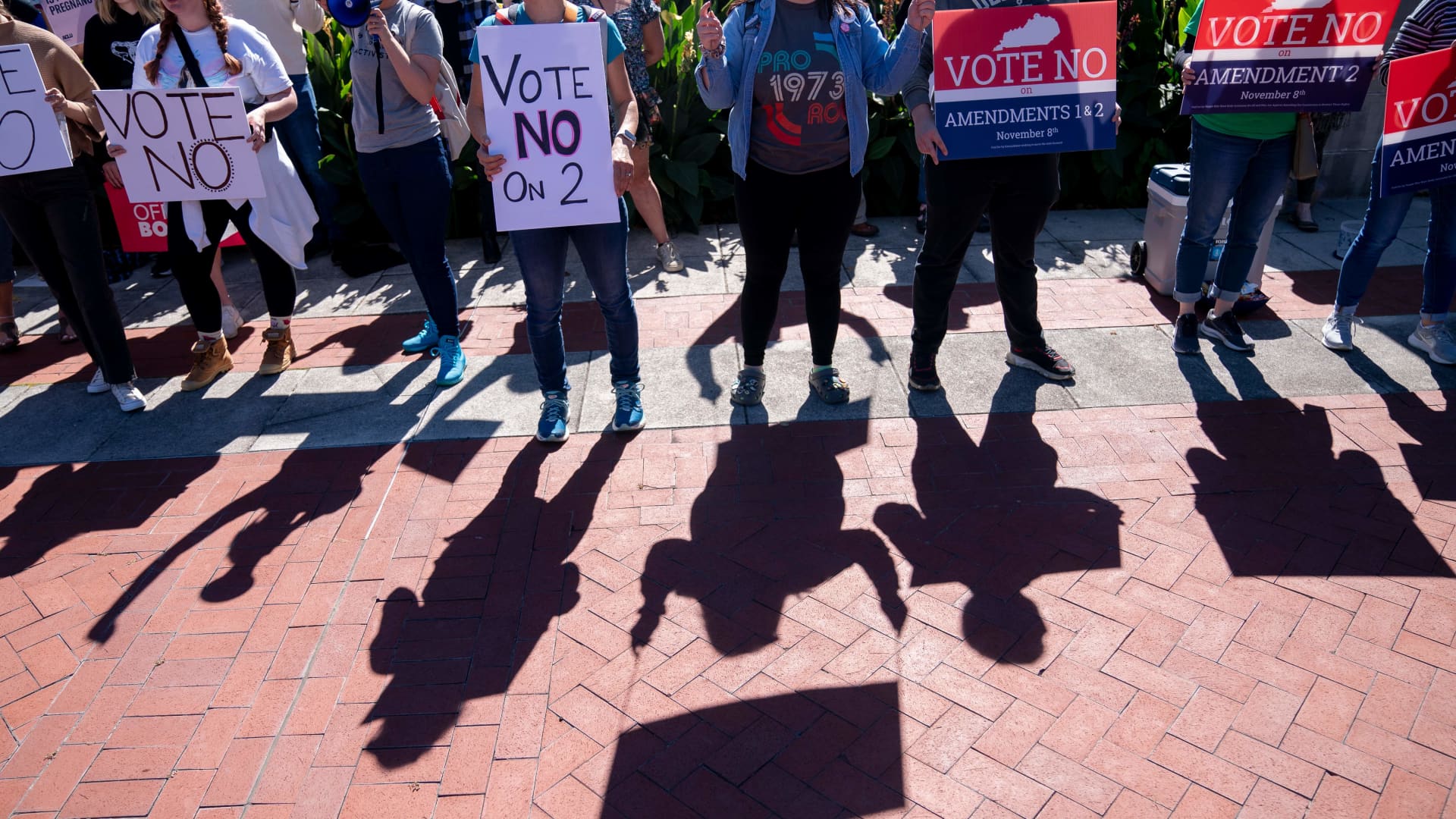 Counter-protestors hold signs in front of a rally encouraging voters to vote yes on Amendment 2, which would add a permanent abortion ban to Kentuckys state constitution, on the steps of the Kentucky State Capitol in Frankfort, Kentucky, on October 1, 2022. 