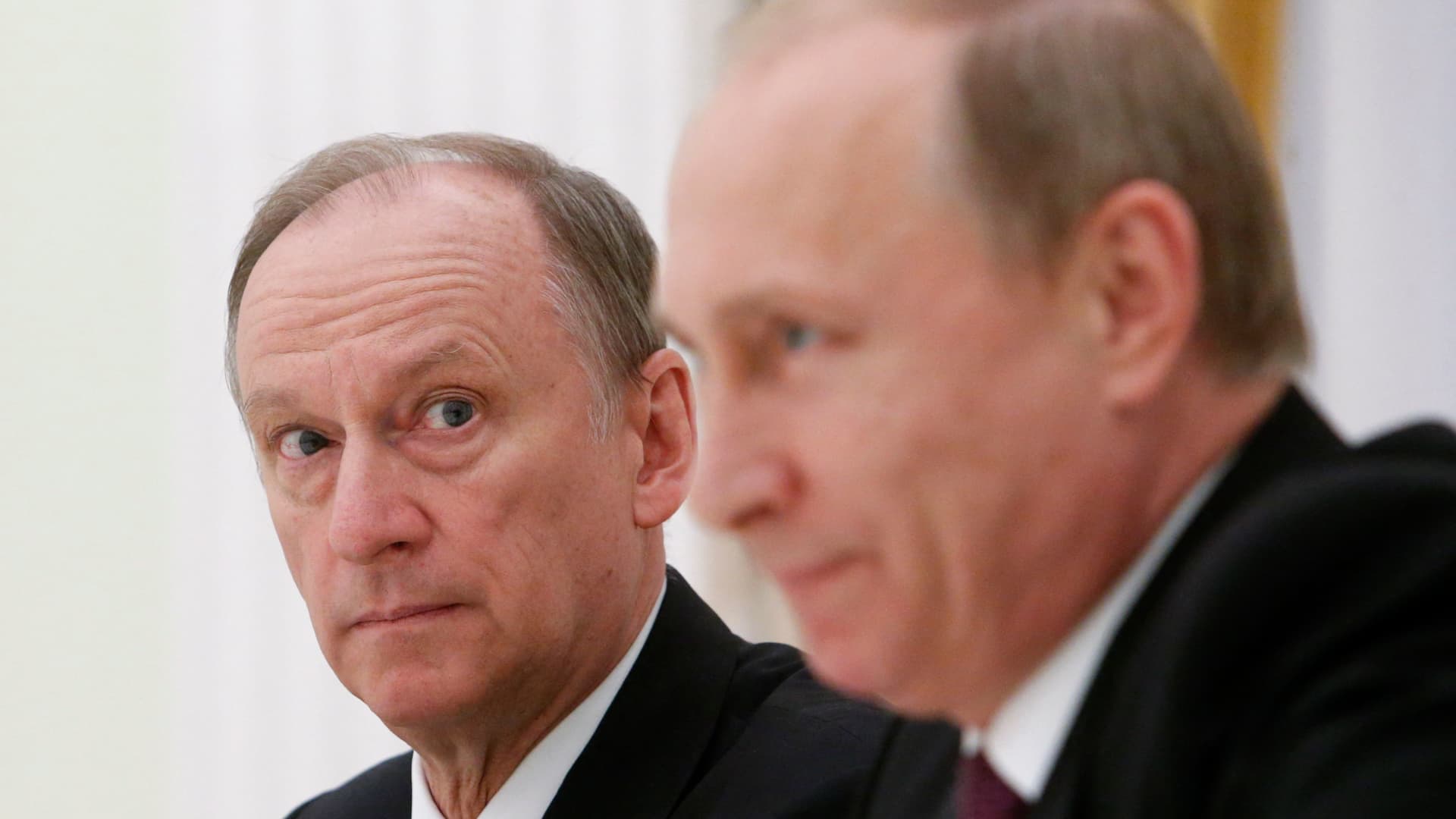 Russian Security Council Secretary Nikolai Patrushev (L) looks at President Vladimir Putin during a meeting with the BRICS countries' senior officials in charge of security matters at the Kremlin in Moscow on May 26, 2015.