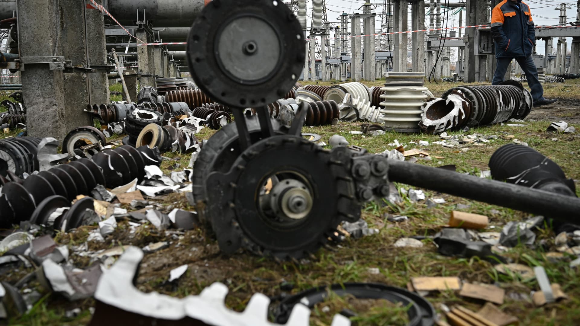 A worker walks past damaged equipment at a high-voltage substation of the operator Ukrenergo after a missile attack, in central Ukraine, on November 10, 2022 amid the Russian invasion of Ukraine.