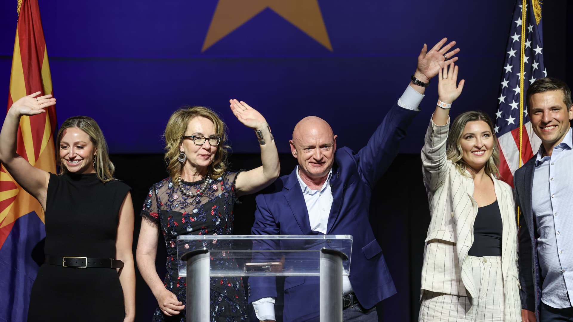 U.S. Sen. Mark Kelly (D-AZ) and his wife former Congresswoman Gabby Giffords, daughters Charlotte, Samantha and son in law Mark Sudman wave during his election night rally at the Rialto Theatre on November 08, 2022 in Tucson, Arizona.